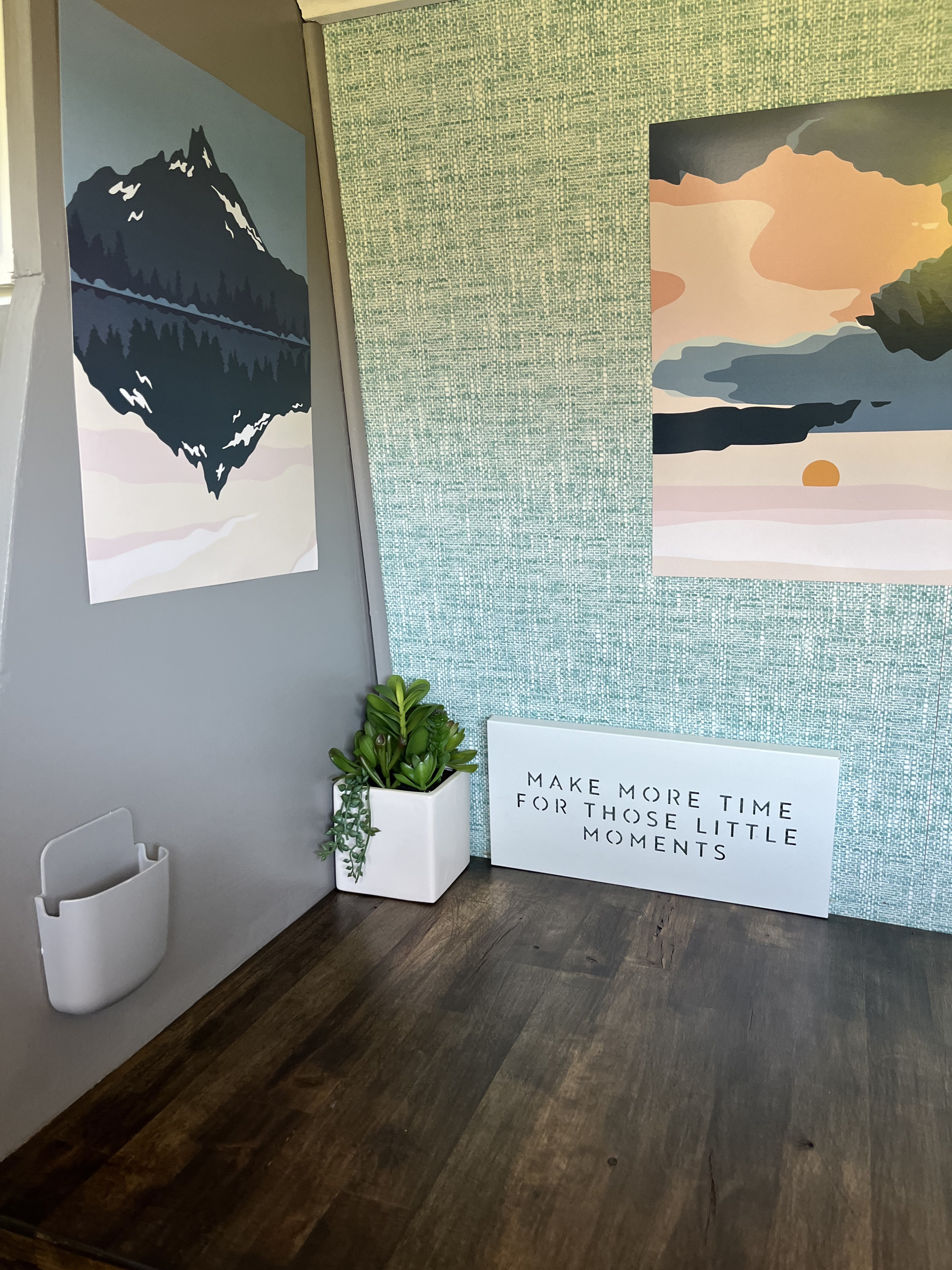 Cozy RV rental interior: mountain & sunset art, textured green wall, white caddy, succulent plant, and inspiring sign.. Mercedes-Benz Sprinter 2013