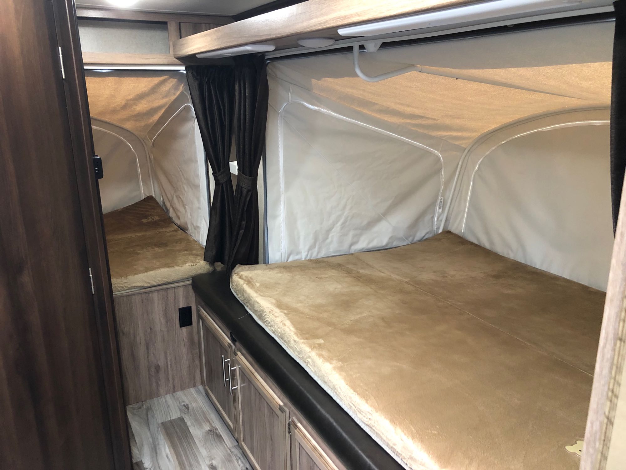 RV rental: Interior view featuring two pop-out beds with soft tan mattresses and wood-look cabinetry.. Jayco Jay Feather 2018