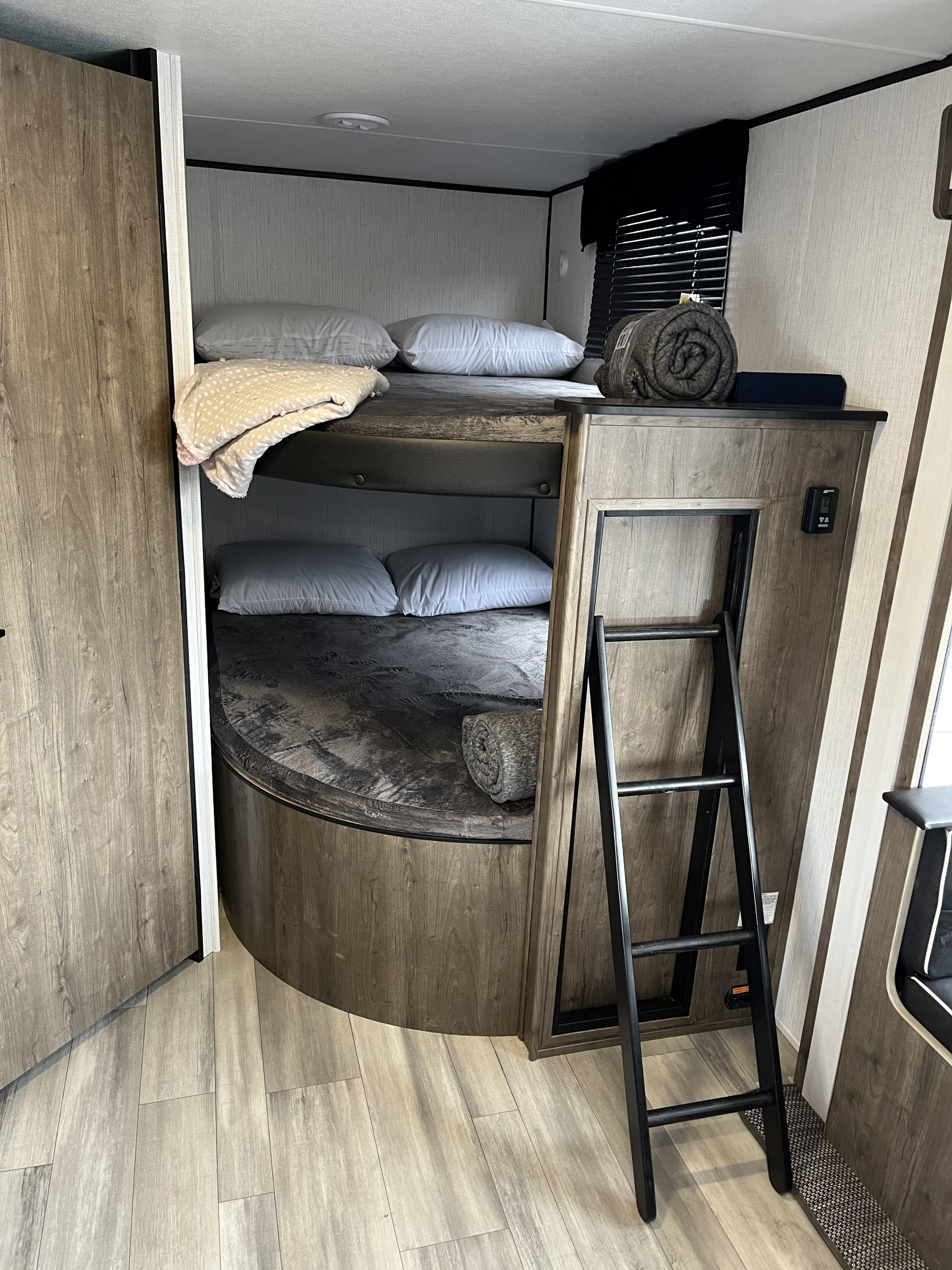 RV rental bunk beds provide comfy sleeping, with pillows, blankets, and a ladder for upper bunk access.. Heartland Pioneer BH270 Bunkhouse 2022