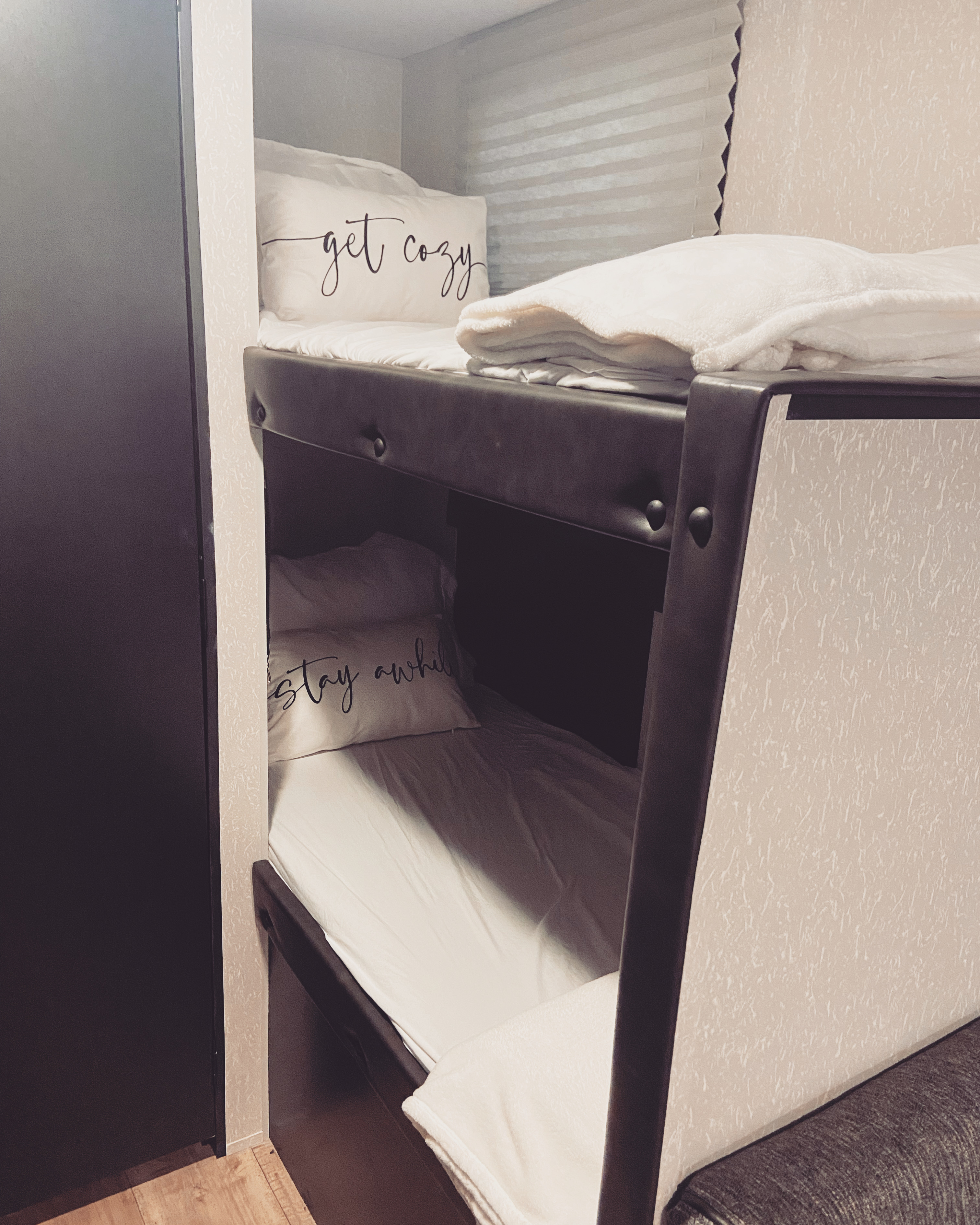 Clean & cozy bunk beds in this RV rental, featuring "get cozy" & "stay awhile" pillows for a comfortable night's sleep.. Forest River Cherokee Wolf Pup 2022