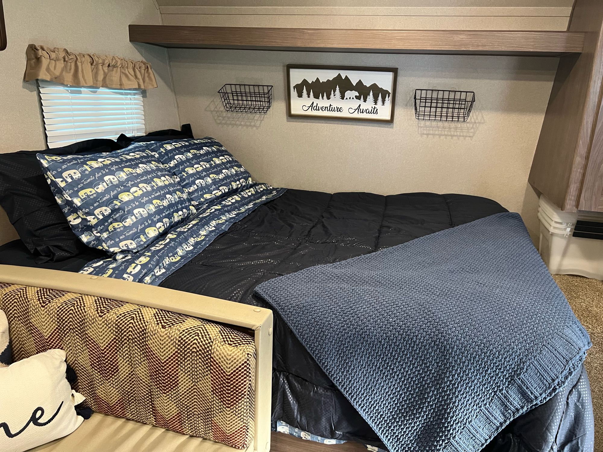 Enjoy a comfortable sleep on a queen size bed! USB chargers at the foot of the bed with baskets on the wall to hold your electronics at night.. Keystone RV Hideout LHS Mini 2019