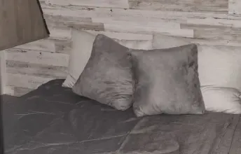 Master bedroom, queen bed with side cabinets and TV. Forest River Palomino Puma XLE Lite 2021