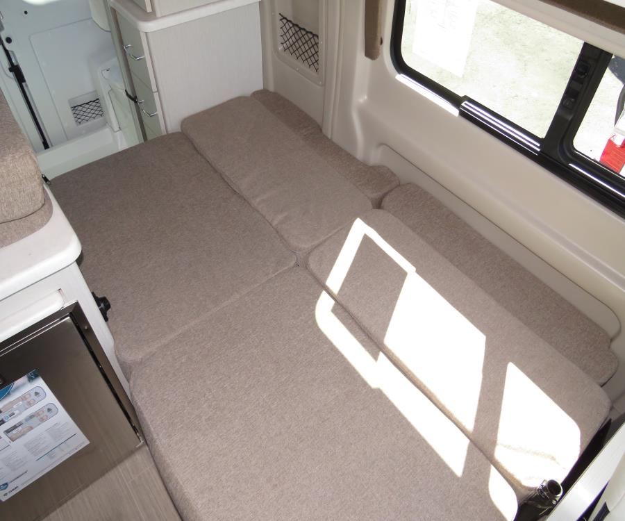 RV rental's versatile interior: modular cushions create a comfortable bed/lounge, perfect for camper adventures.. Thor Rize 2022