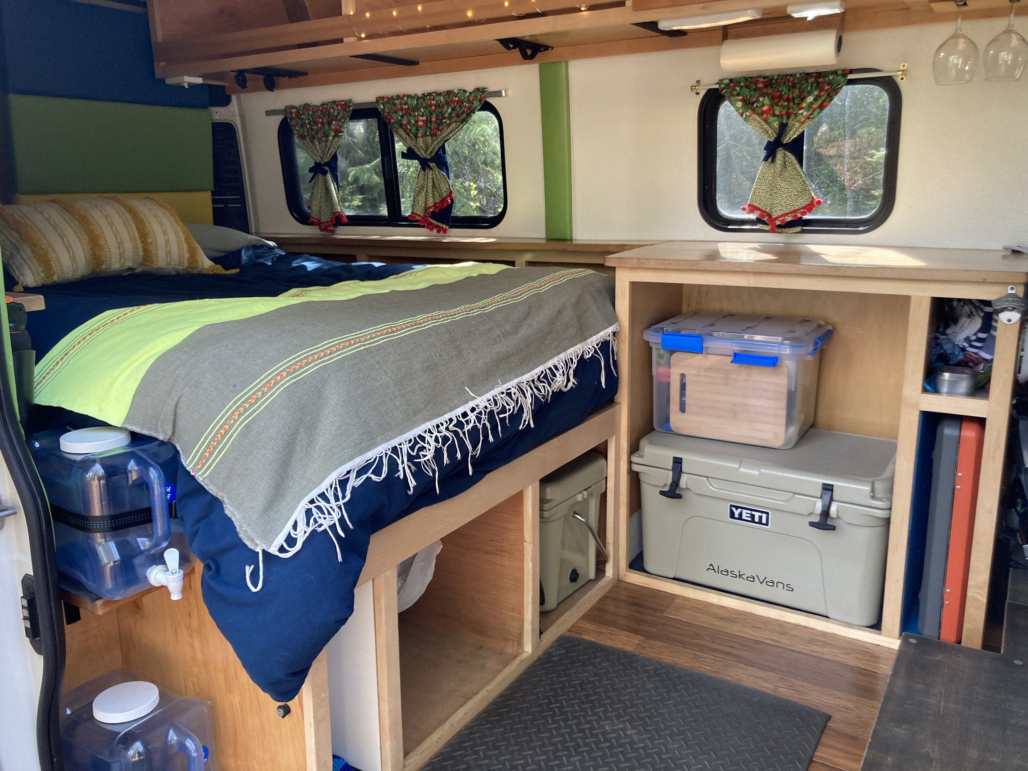 Cozy RV rental camper van interior with a comfortable bed, smart storage solutions, and scenic windows.. Dodge 1500 2016