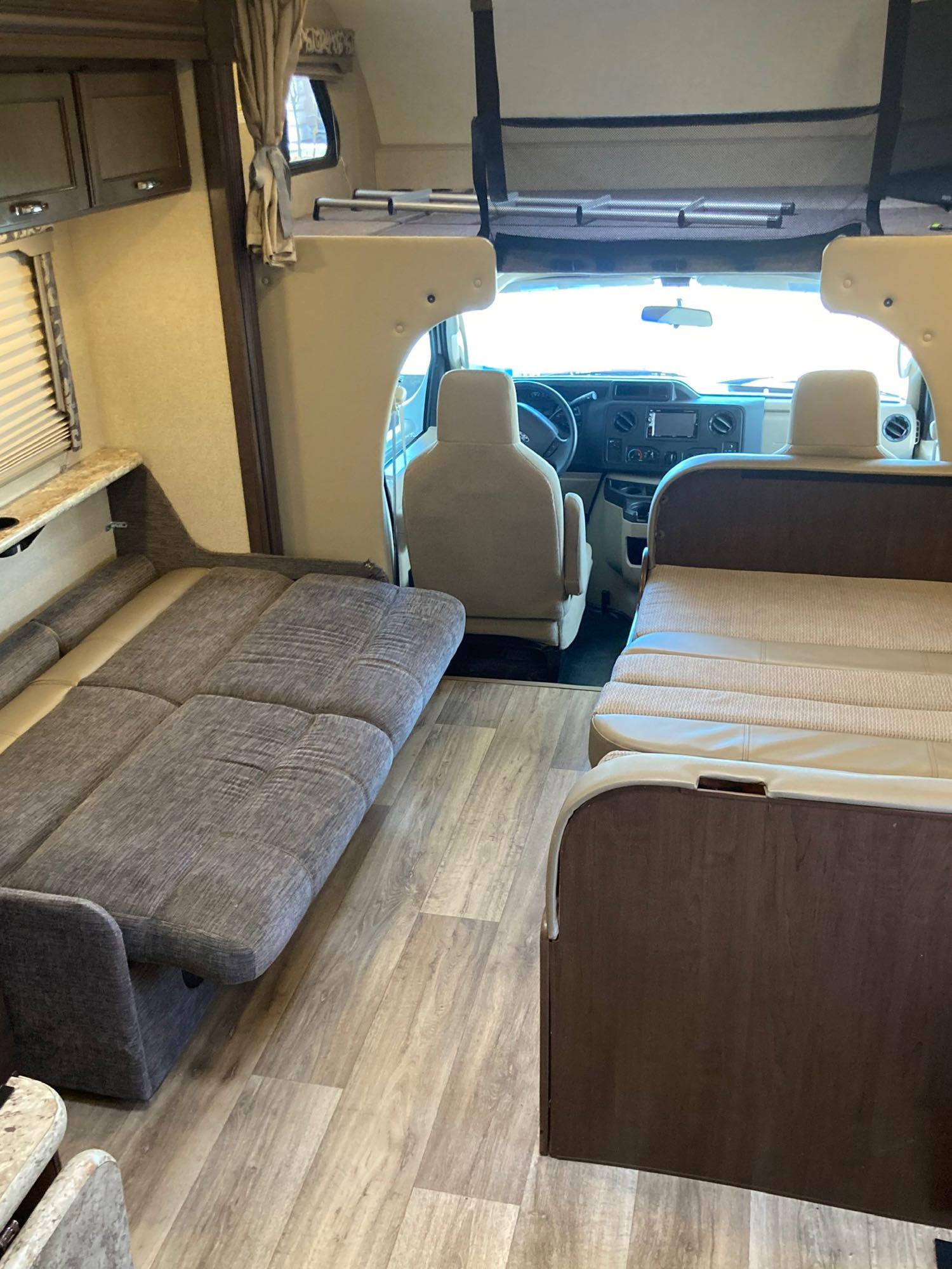 RV rental interior: convertible sofa-bed, dinette, and overhead bunk provide adaptable living & sleeping space.. Thor Four Winds 2018