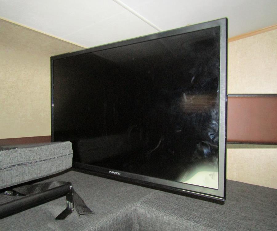 Furrion TV in an RV rental, providing entertainment in a compact living space.. Coachmen Leprechaun 2017