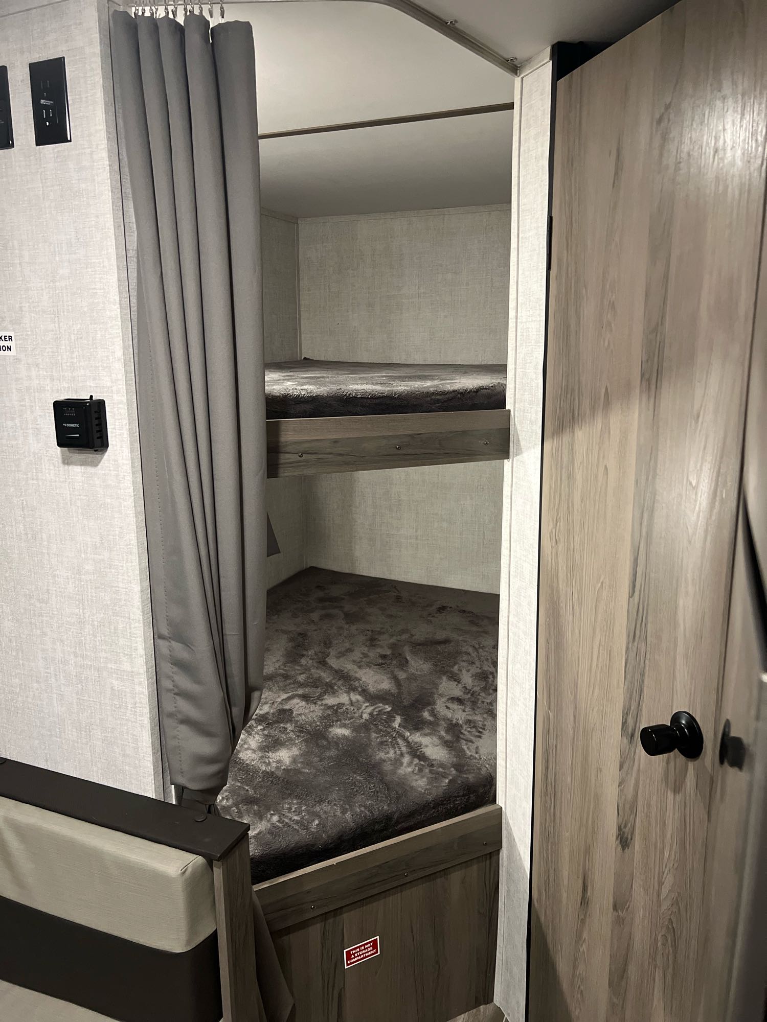 RV rental bunk beds with privacy curtain, showing essential outlets and a comfortable sleeping area for guests.. Gulf Stream Gulfstream 2022
