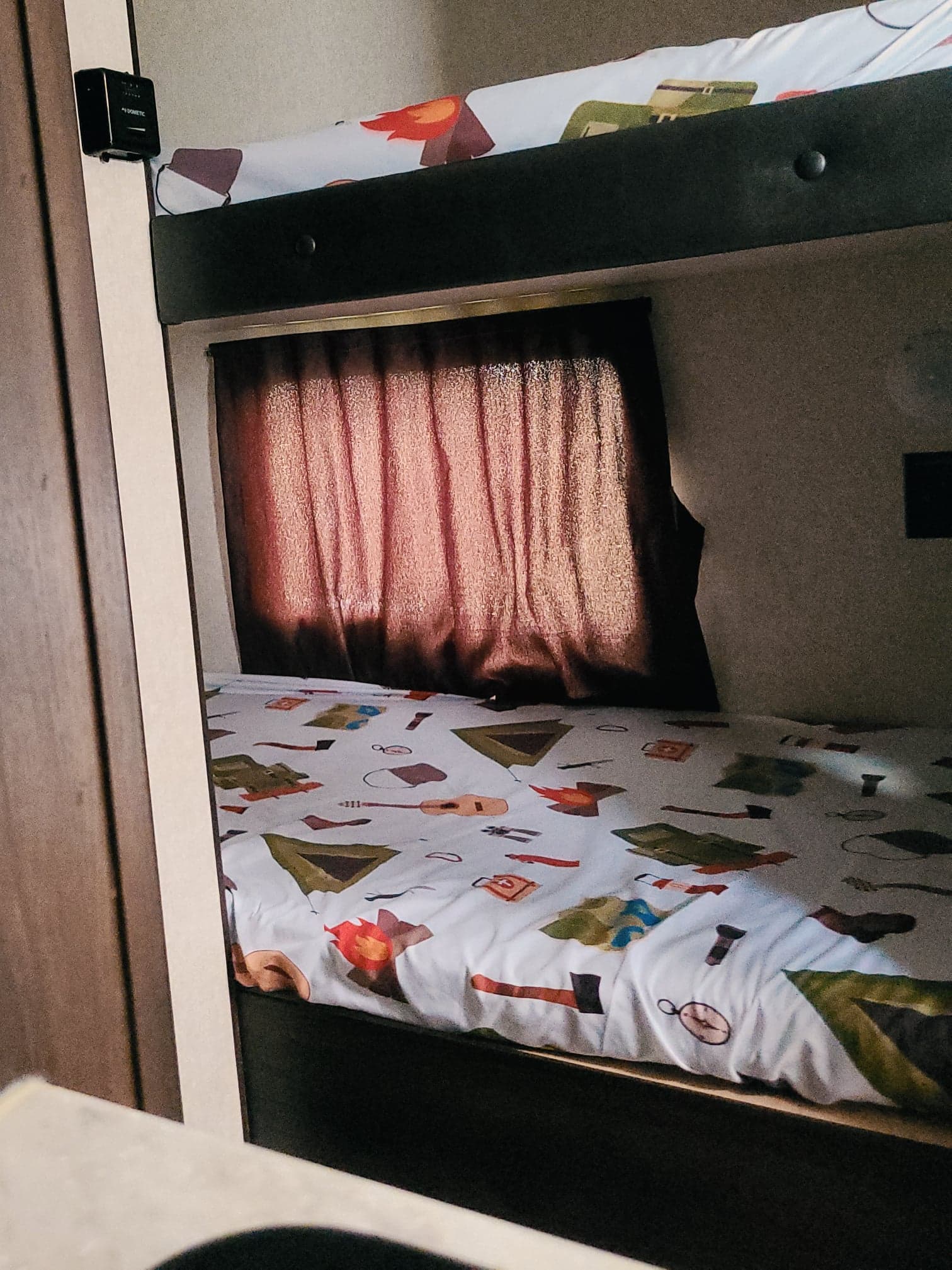 Cozy bunk beds with adventurous camping-themed bedding and a private window in an RV rental.. Jayco Jay Flight SLX 2019