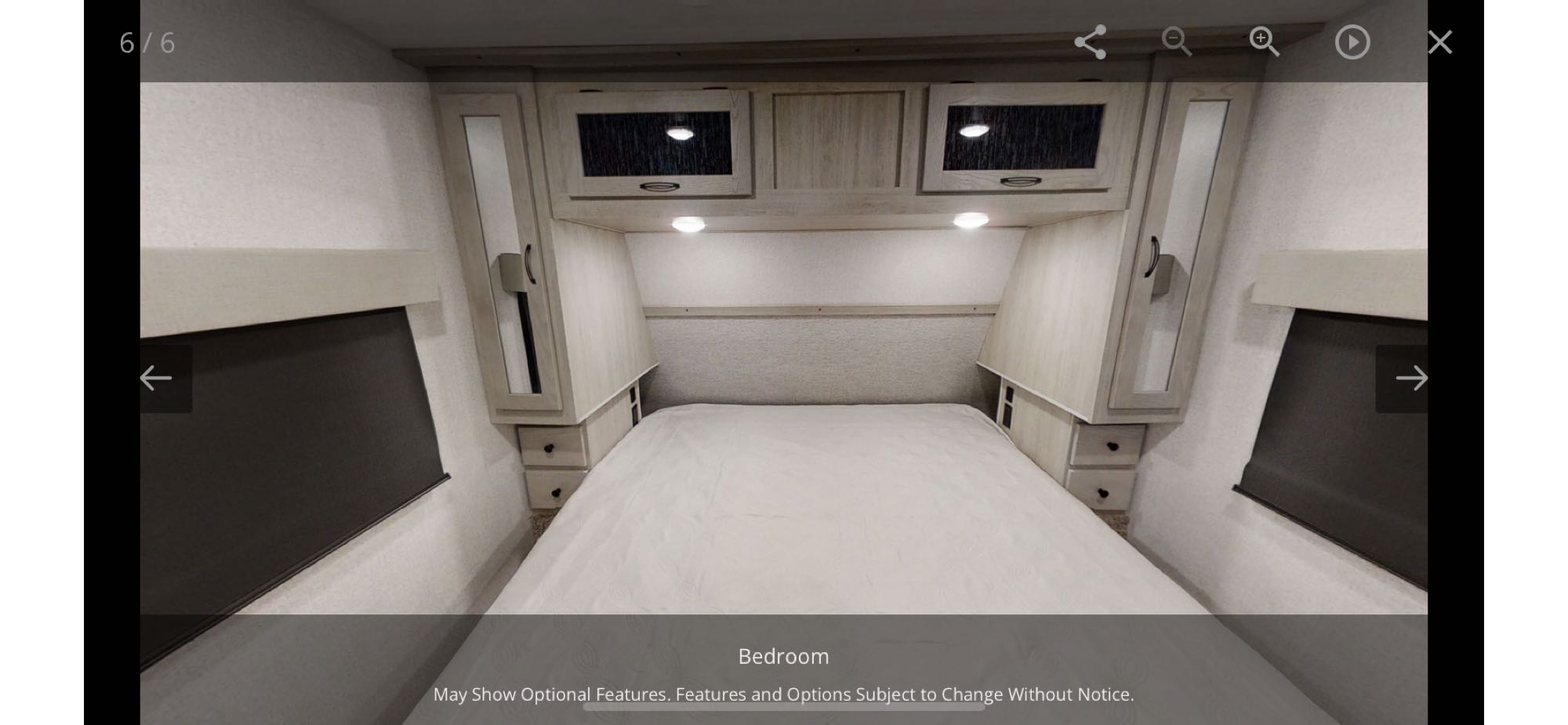 Cozy RV rental bedroom featuring a comfortable bed, overhead cabinets with lighting, and convenient side storage.. Forest River Other 2022