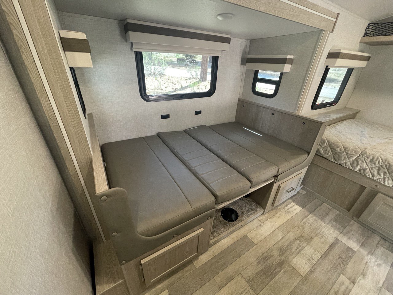 RV rental interior: Spacious dinette seating converts to a bed, complementing a dedicated sleeping area. Great for camper travel.. Forest River Other 2022
