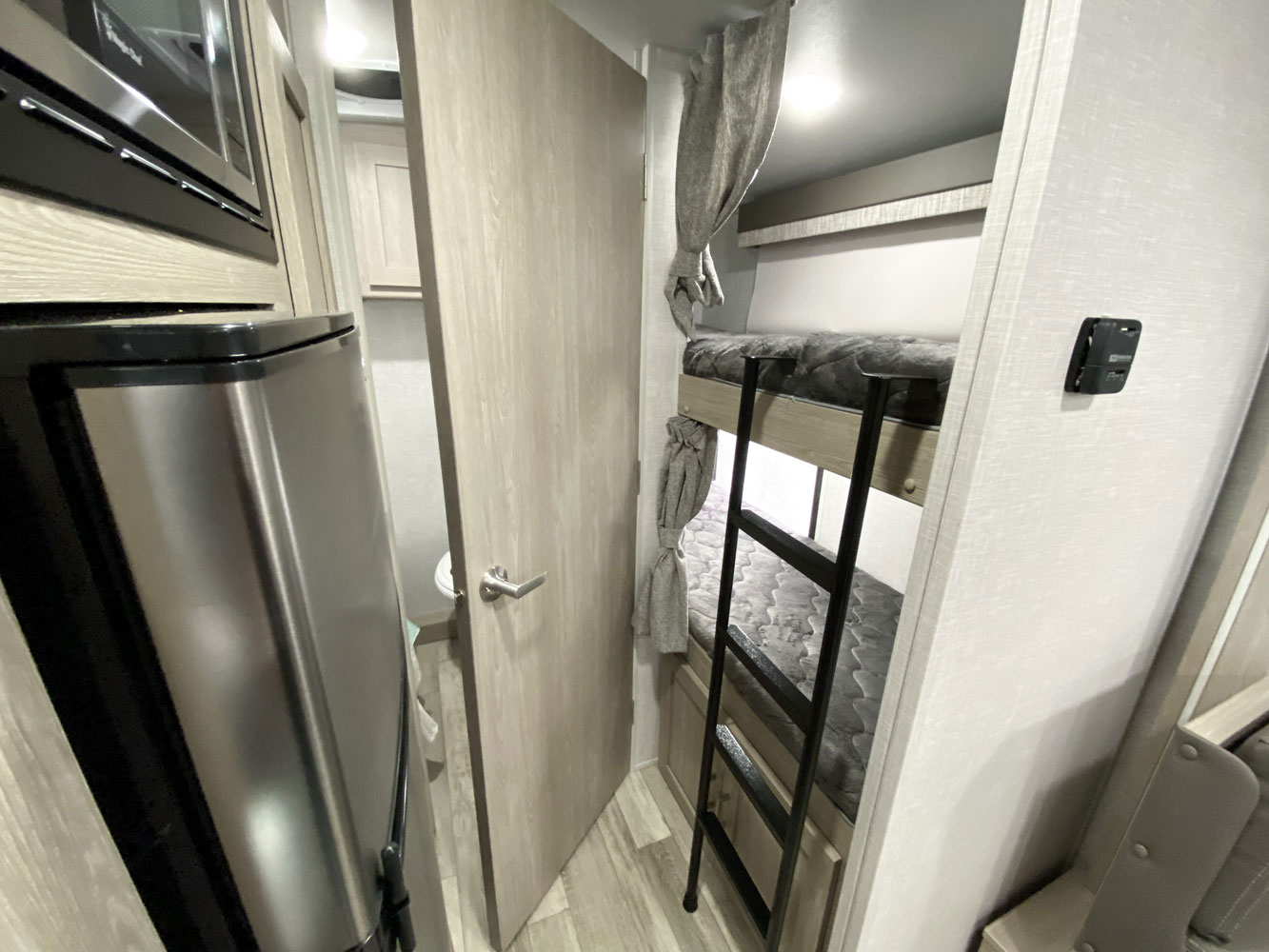 This RV rental features a compact kitchen with a microwave & fridge, a private bathroom, and stacked bunk beds with a ladder.. Forest River Flagstaff E-Pro 20BHS 2022