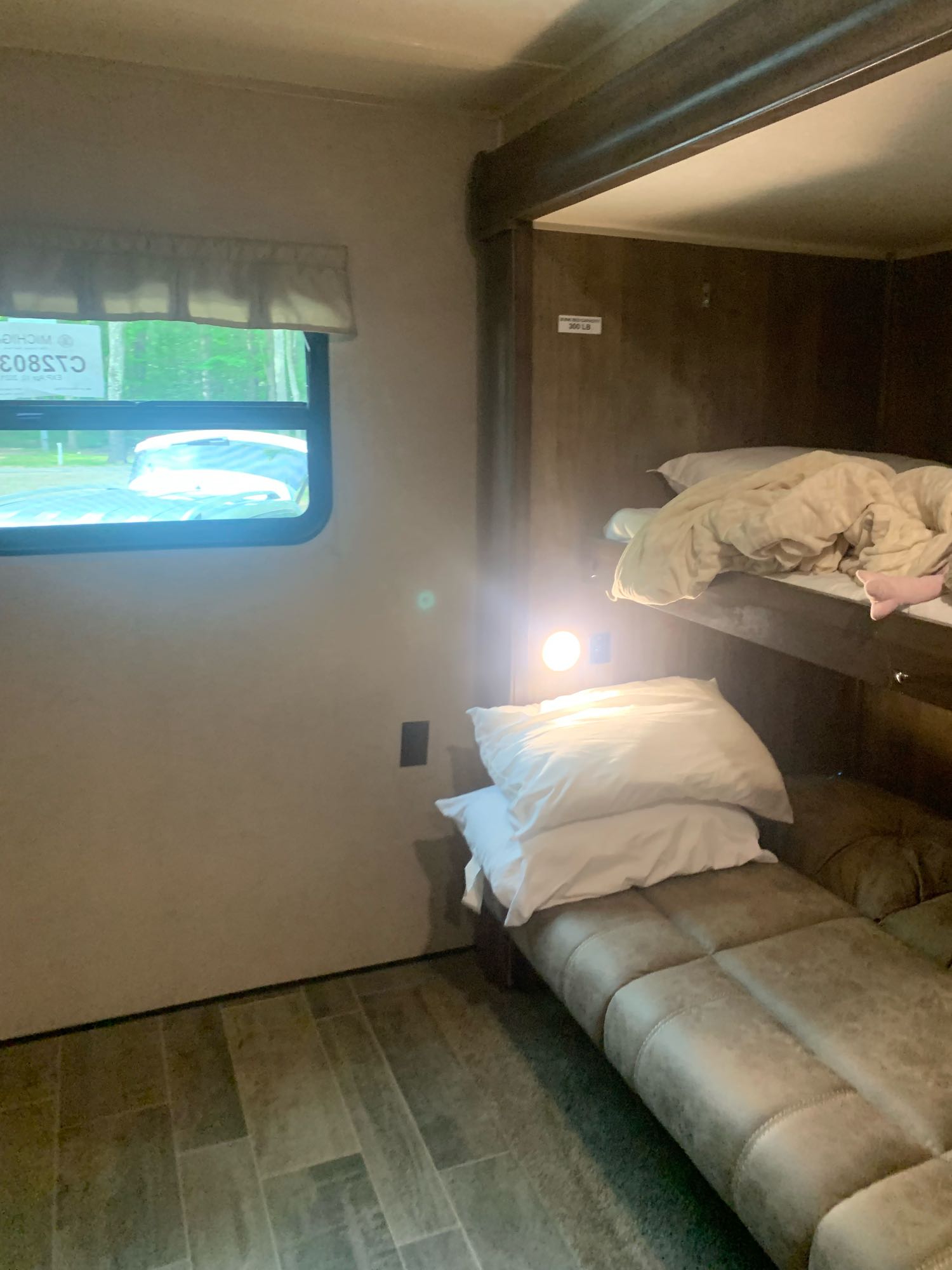 Step inside this RV rental: comfortable bunk beds, a bright reading light, and a window view of nature await your next adventure.. Palomino Puma 2018