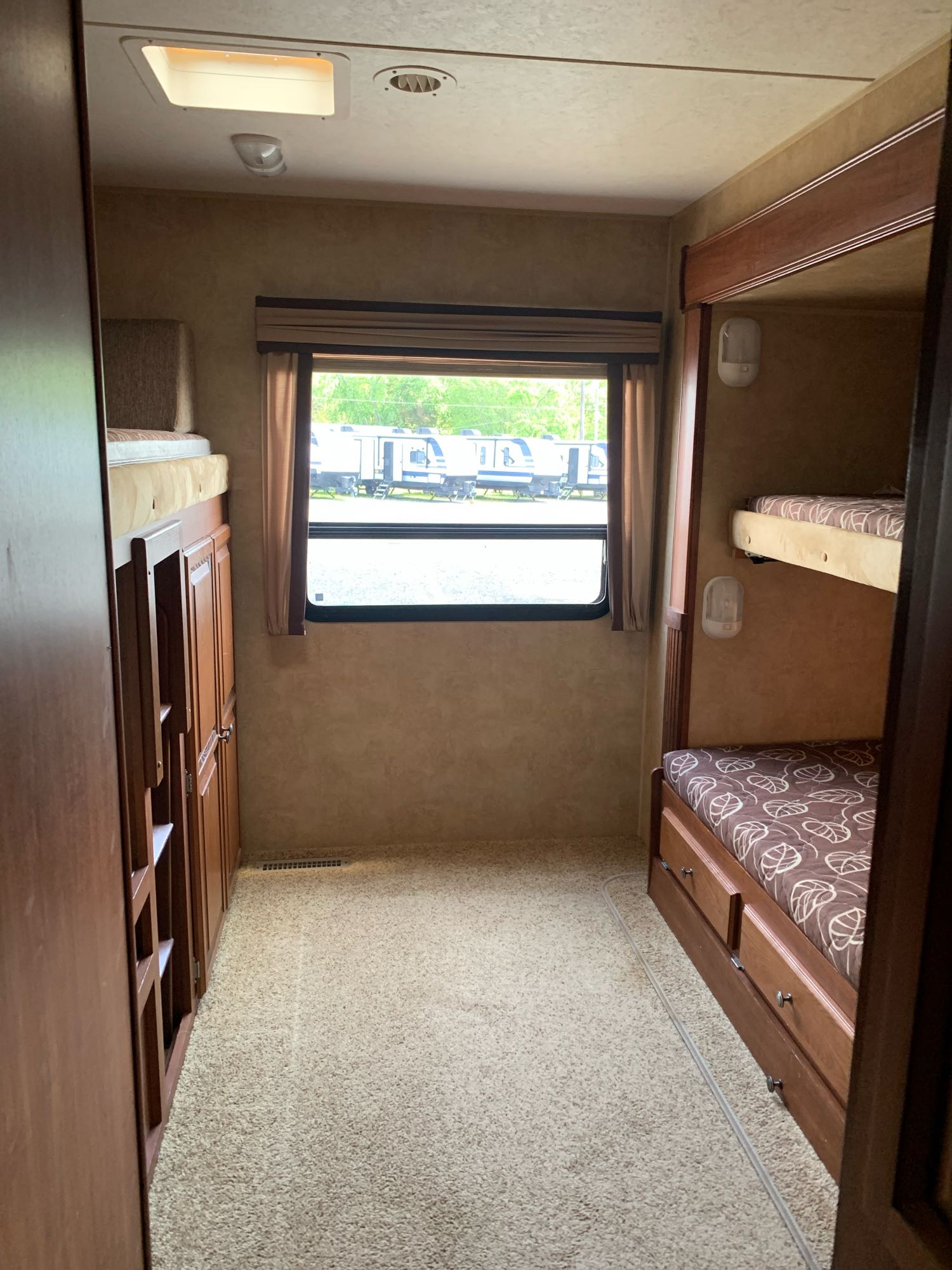 Inside an RV rental bunkhouse: two sets of bunk beds, storage, and a window. Ideal for families.. Jayco Eagle Super Lite 2012