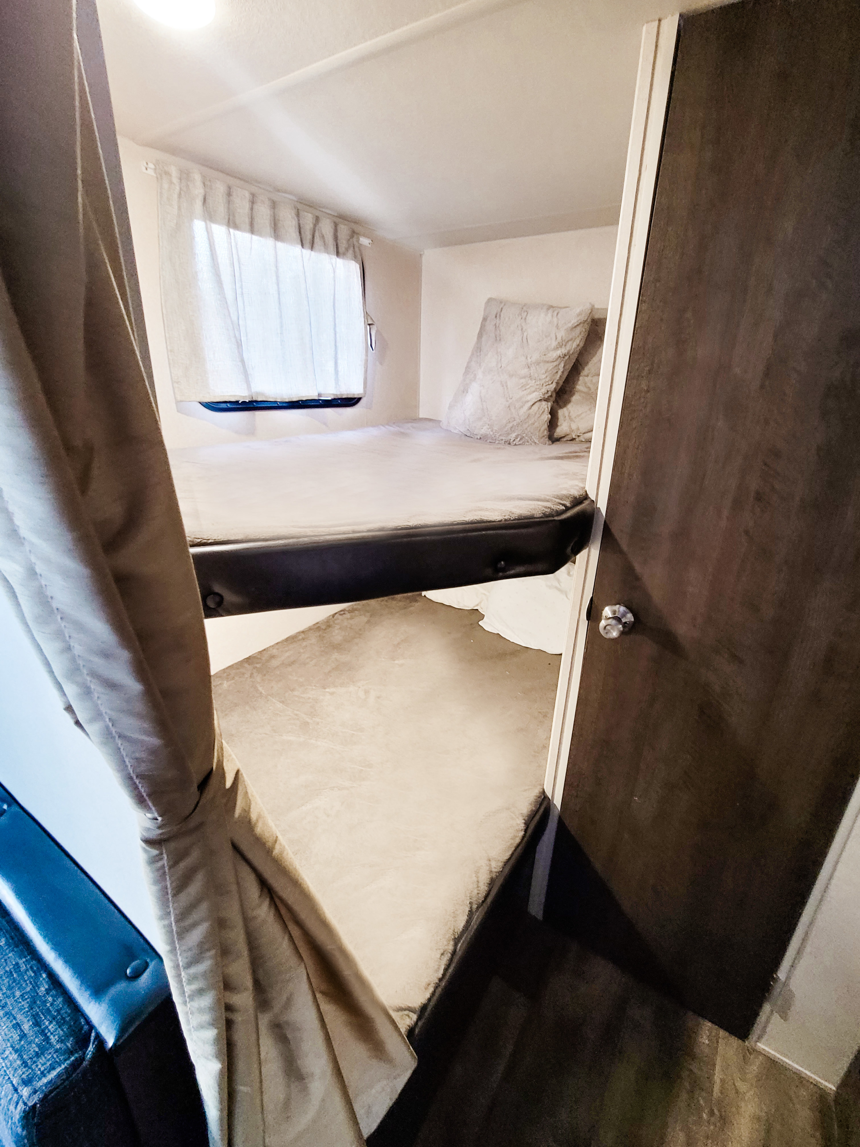 Inside an RV rental showing stacked bunk beds.. Forest River Salem Cruise Lite 2018