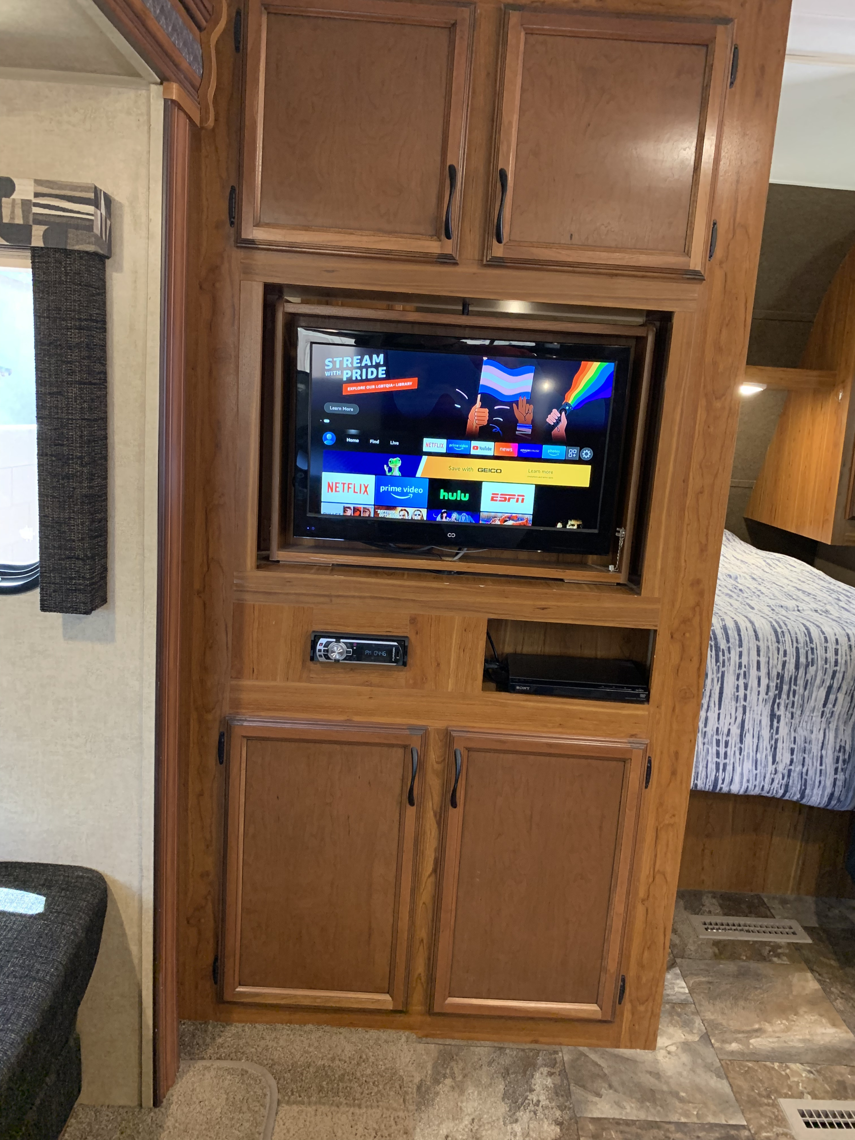 RV rental's entertainment center: TV shows streaming apps & 'Stream with Pride' content. Stereo and Sony DVD player below.. Starcraft AR-One Maxx 2015