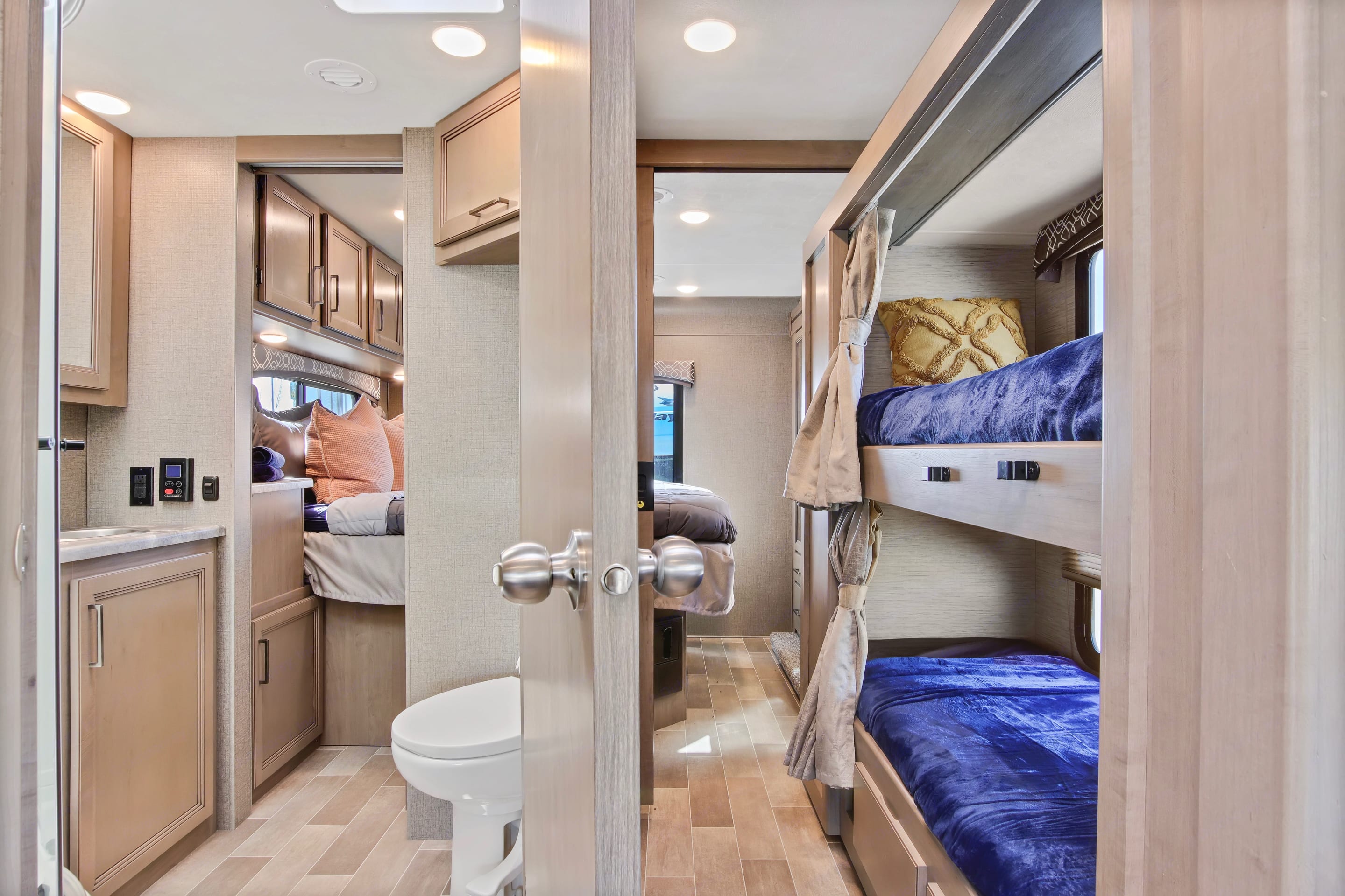Tour this RV rental's interior: a comfortable main bed, two cozy bunk beds, and a compact bathroom.. Thor Chateau 2021