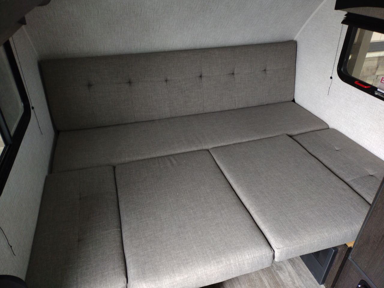 RV rental: The gray convertible dinette/bed in this camper's compact interior offers versatile seating and sleeping.. Braxton Creek Bushwhacker Plus 2021