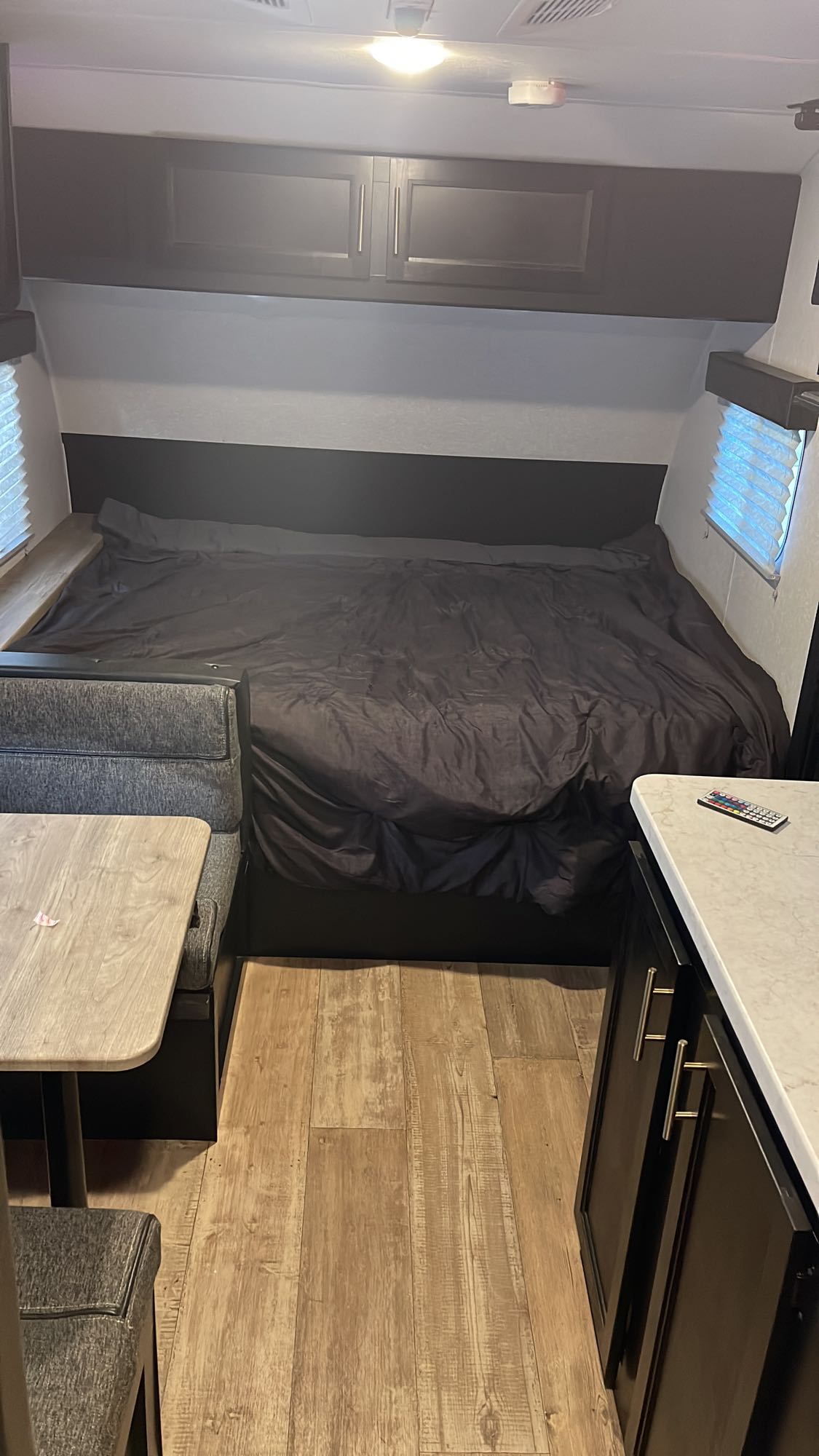 RV rental: full view of the interior showing a bed, dinette with bench seating, and kitchen counter.. Forest River Cherokee Wolf Pup 2022