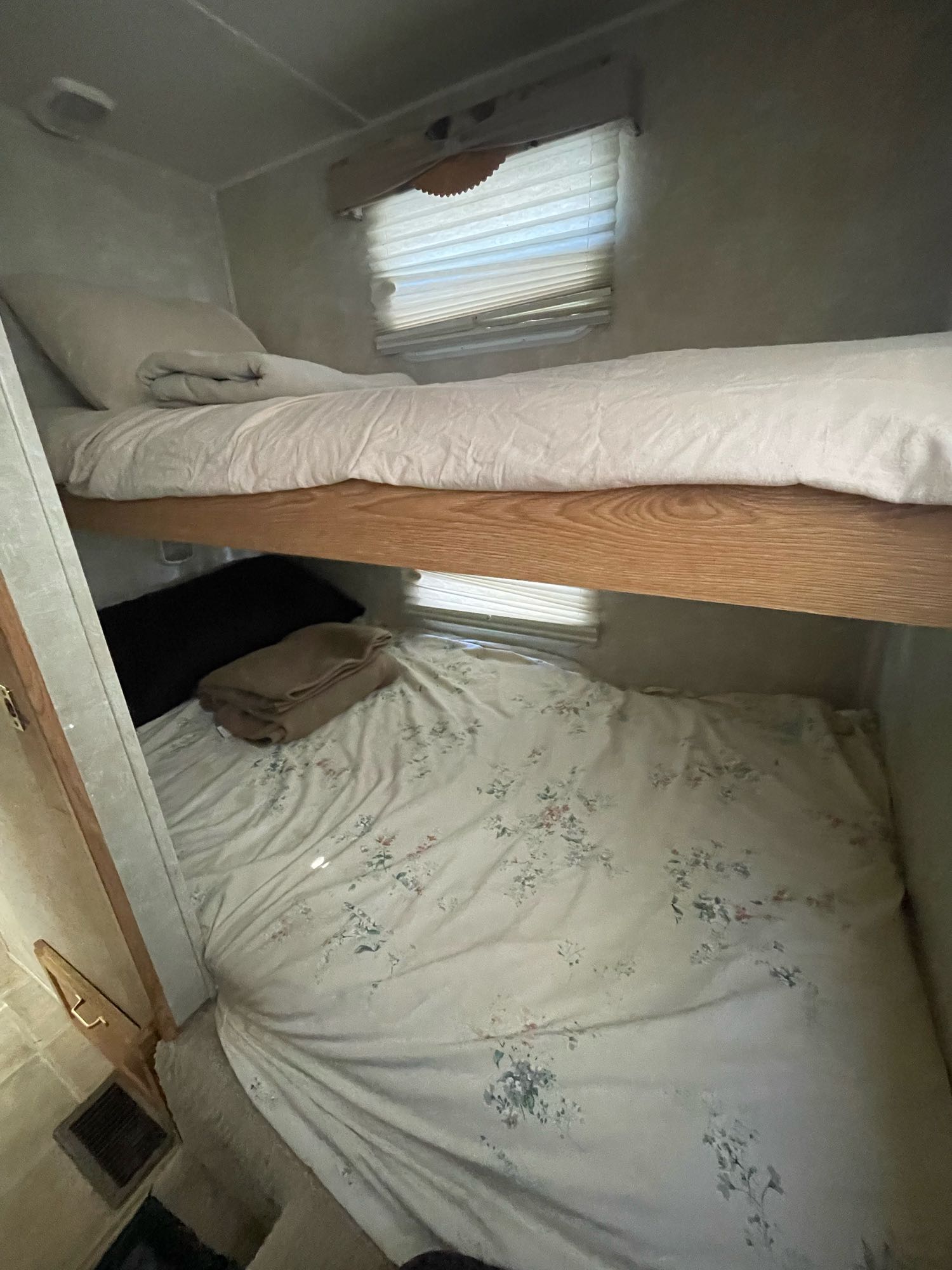Inside an RV rental, comfortable bunk beds are ready with bedding, ideal for road trips.. Wildcat Wildcat Trailer 2004