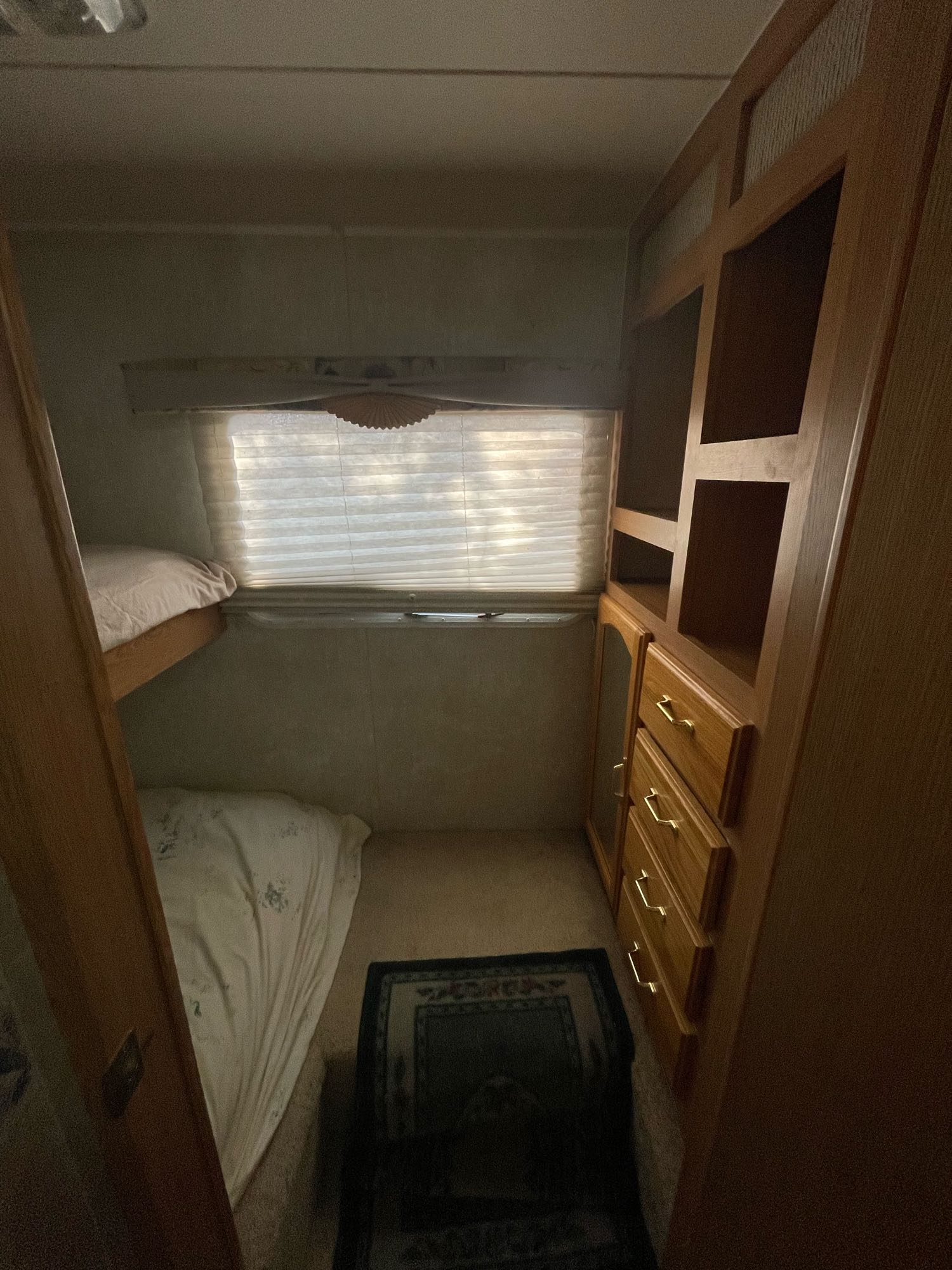 Cozy RV rental bunk beds, window with blinds, and built-in storage. Perfect compact sleeping space for trips.. Wildcat Wildcat Trailer 2004
