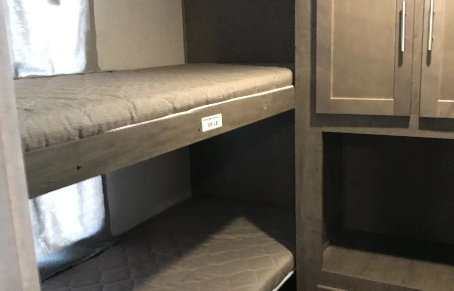 RV rental bunk beds feature cozy mattresses & practical built-in storage. Ideal for family adventures on the road.. Forest River Surveyor 2017