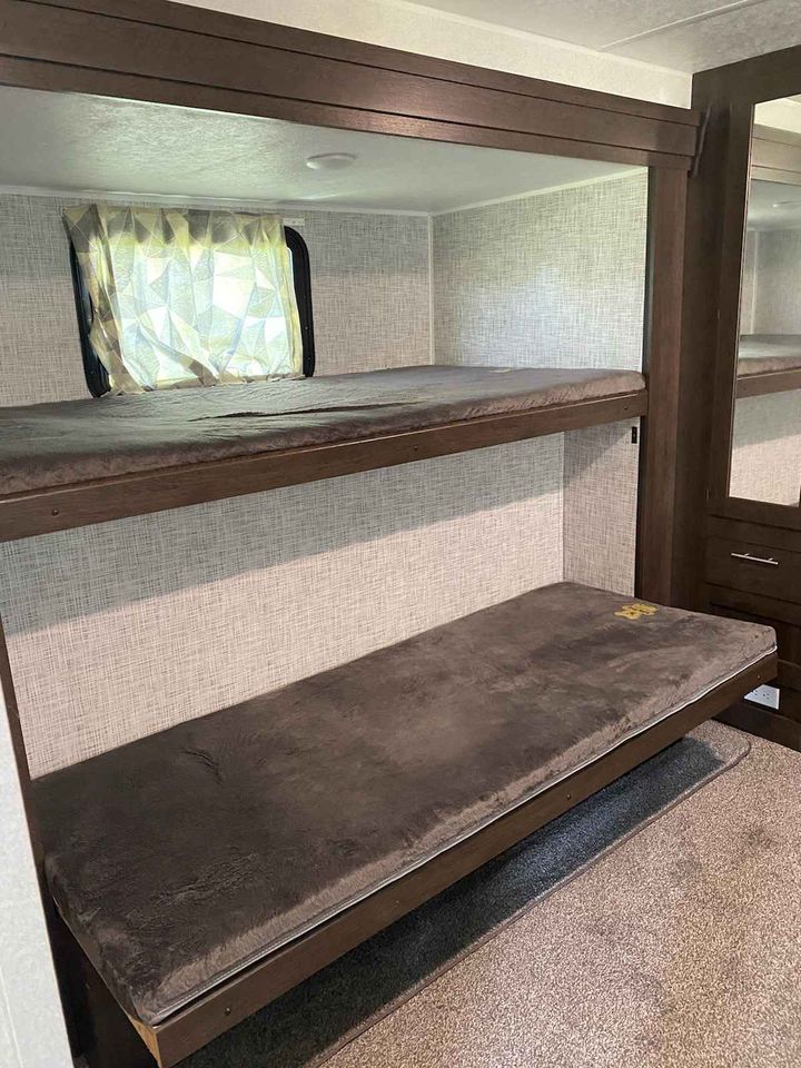 RV rental: Cozy bunk beds in a modern camper interior, perfect for family travel.. Forest River Salem 2020