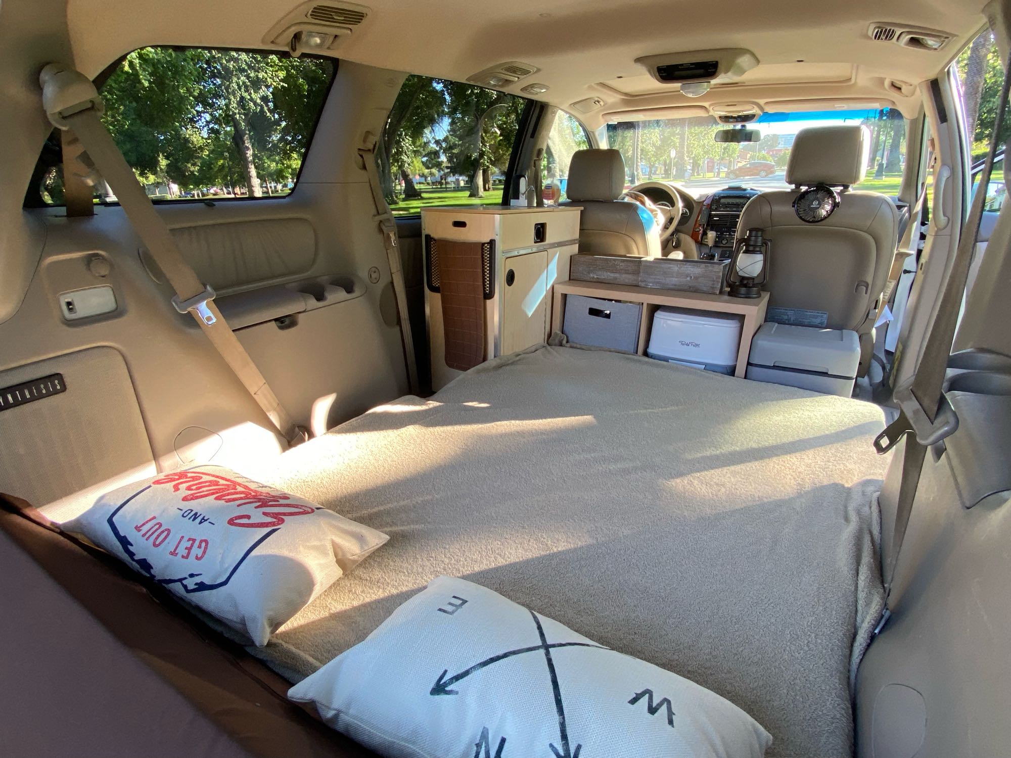 Cozy minivan camper conversion perfect for an rv rental adventure. Features a comfy bed, compact kitchen, & storage for road trips.. Custom Camper 2004
