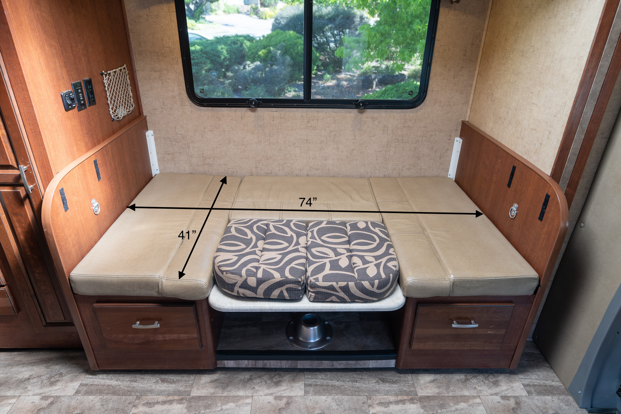 RV rental dinette converts to a 74"x41" bed. Features tan cushions, storage drawers, and a central table base.. Forest River Forester 2401W 2016