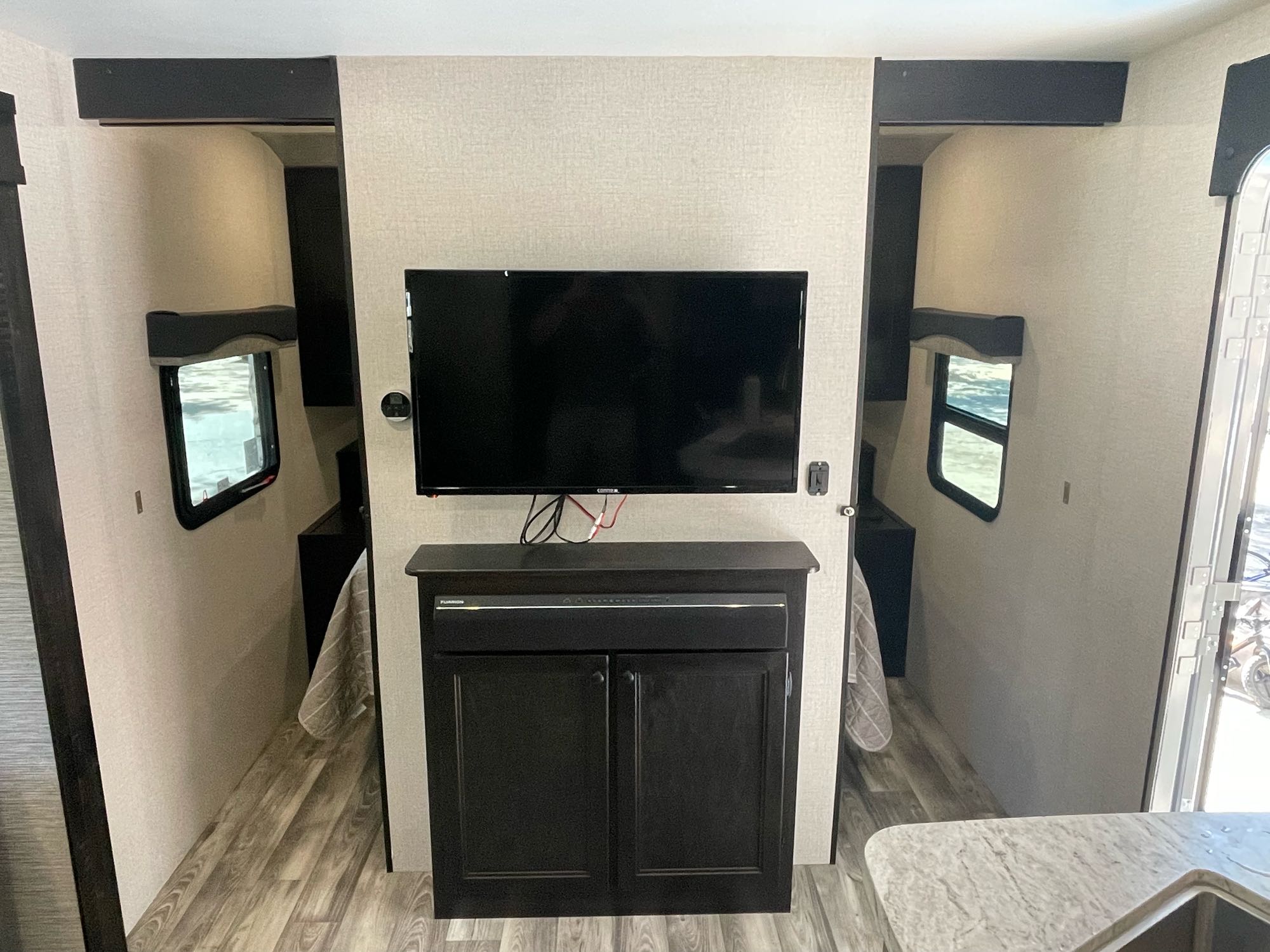 Explore this RV rental's interior: a central living space with TV and storage, flanked by two bedrooms.. Starcraft Superlite 261BH 2022