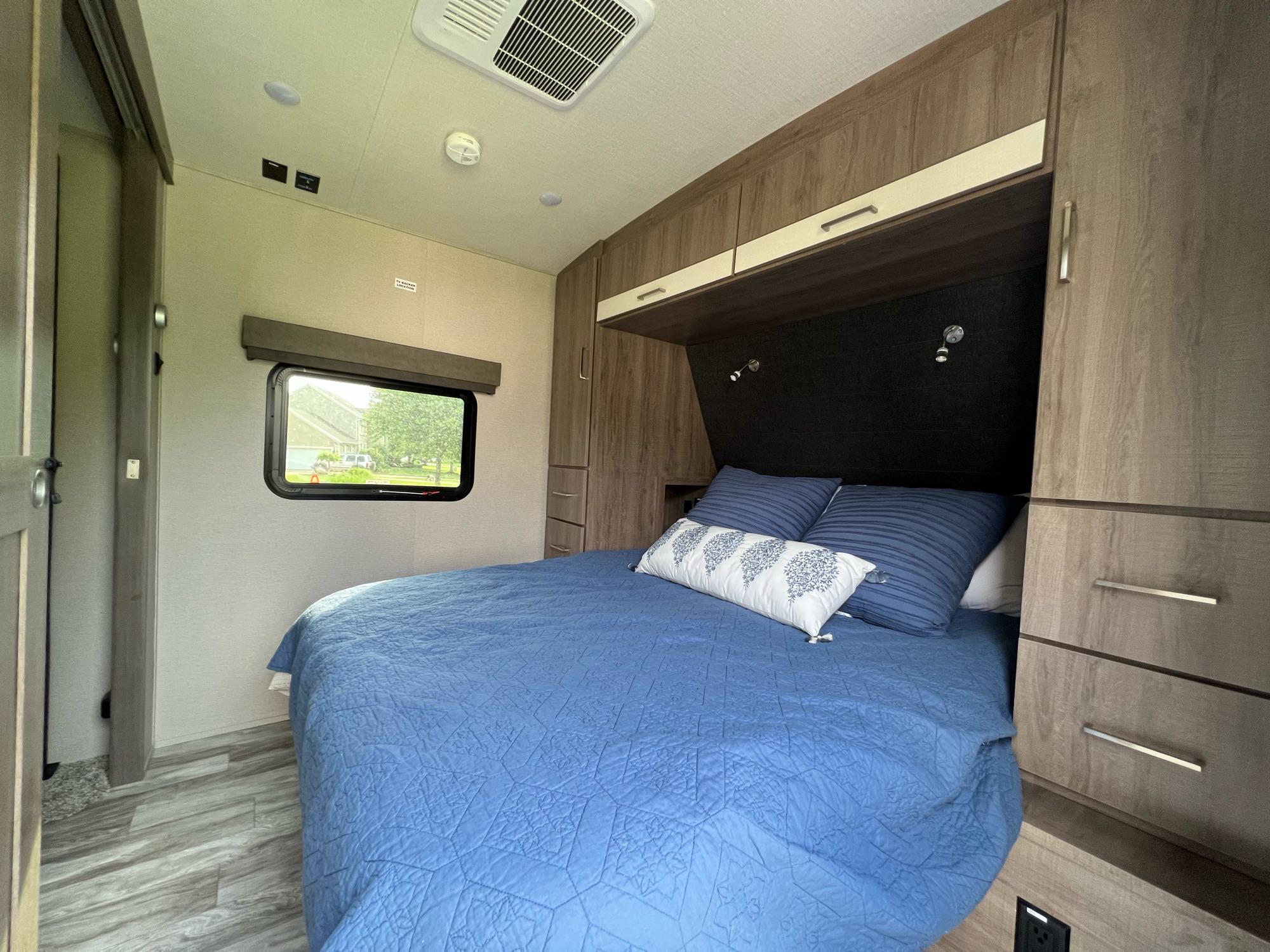 Step inside this inviting RV rental bedroom. Features a comfy bed, ample storage, and a scenic window for mobile living.. Grand Design Imagine 2022