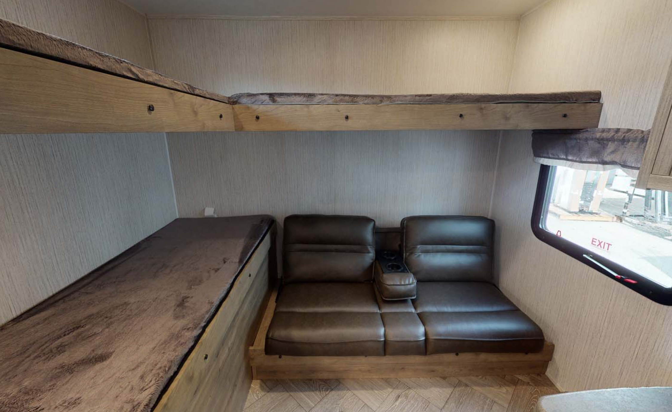 Inside this RV rental: upper and lower bunk beds, a brown leatherette sofa with cup holders, and a window. Ideal for trips!. PUMA 28BHSS 2022