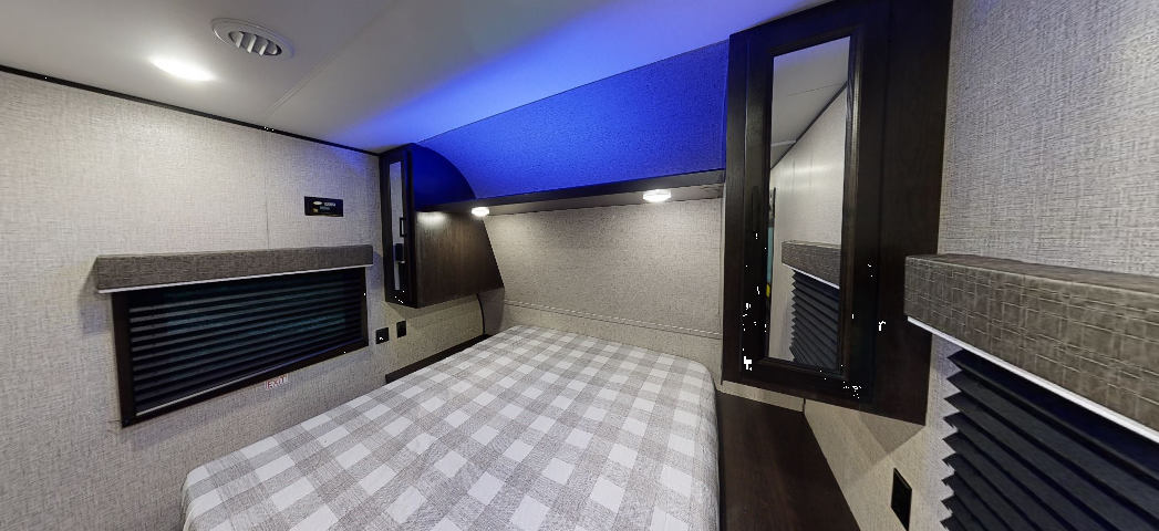 Cozy RV rental bedroom with plaid bedding, overhead storage, and blue ambient lighting. Perfect for your next adventure.. JAYCO Jay Flight SLX 264BH 2022