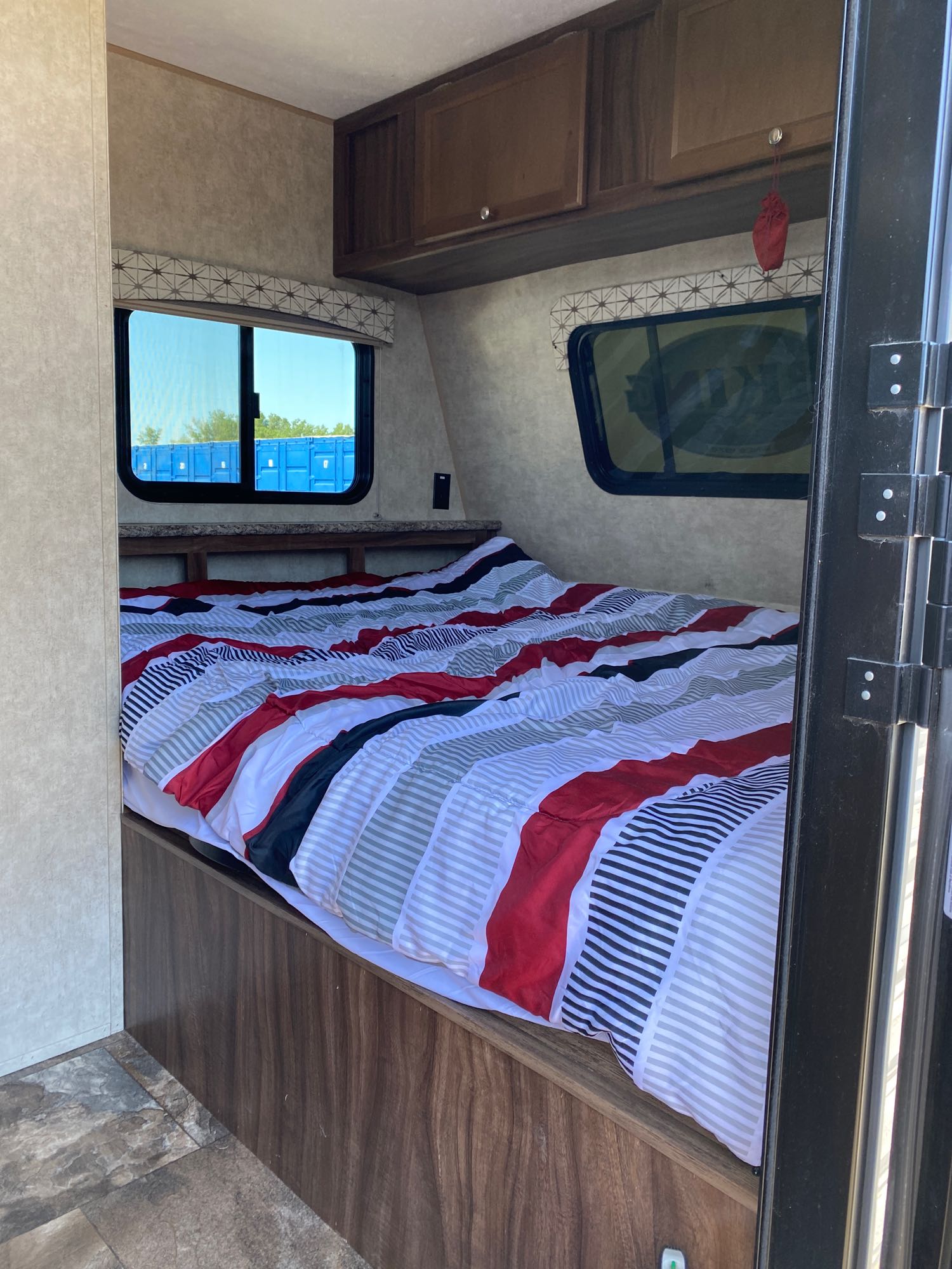 Our comfortable queen bed is just to the right of the door and next to the bathroom.  includes two blackout shades at the head and put up the bed, and an optional front window you can open and close from the outside.. Coachmen Viking 2017