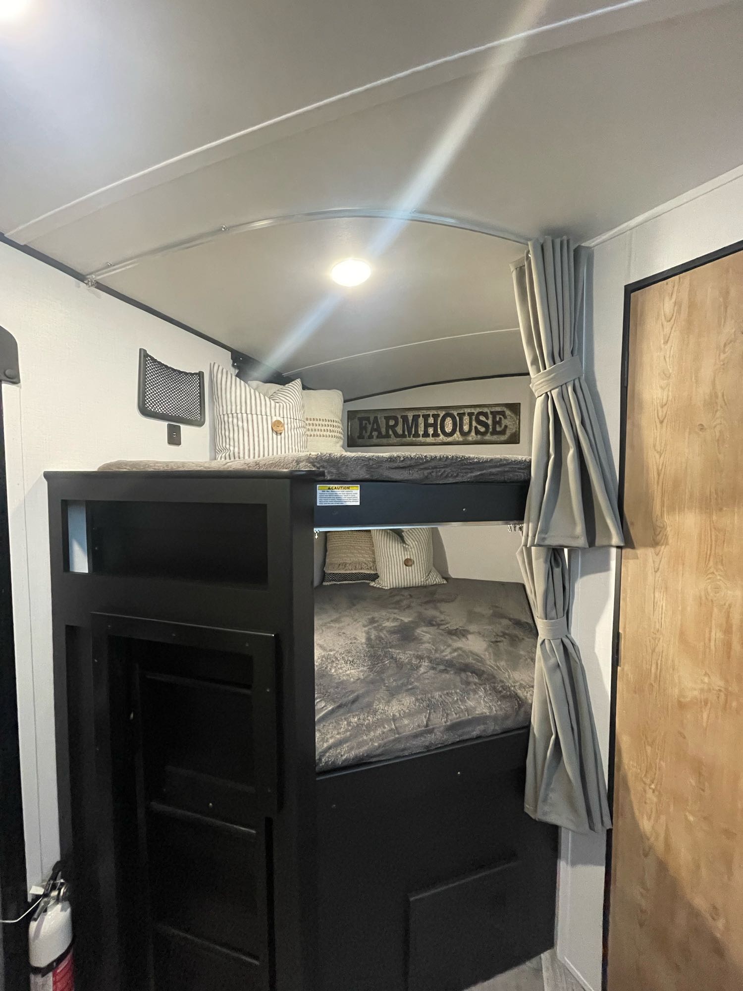 Cozy RV rental interior with bunk beds, farmhouse decor, and practical storage for comfortable travel.. Keystone Springdale 2022