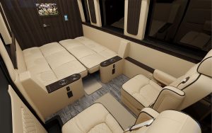 Explore a spacious luxury RV rental interior: cream leather seats, convertible bed, captain's chairs for premium travel.. Ultimate Toys Ultimate Traveler 2023