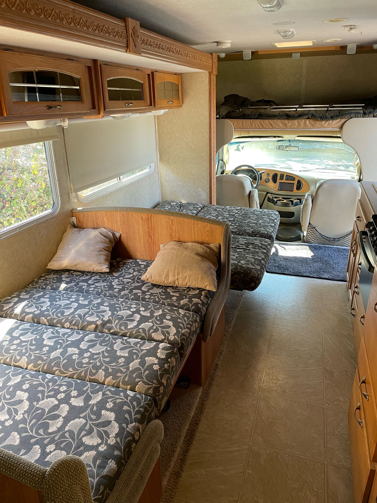 Explore this bright RV rental interior featuring a versatile living area, cozy bunk, and functional kitchen space.. Jayco Greyhawk 2006