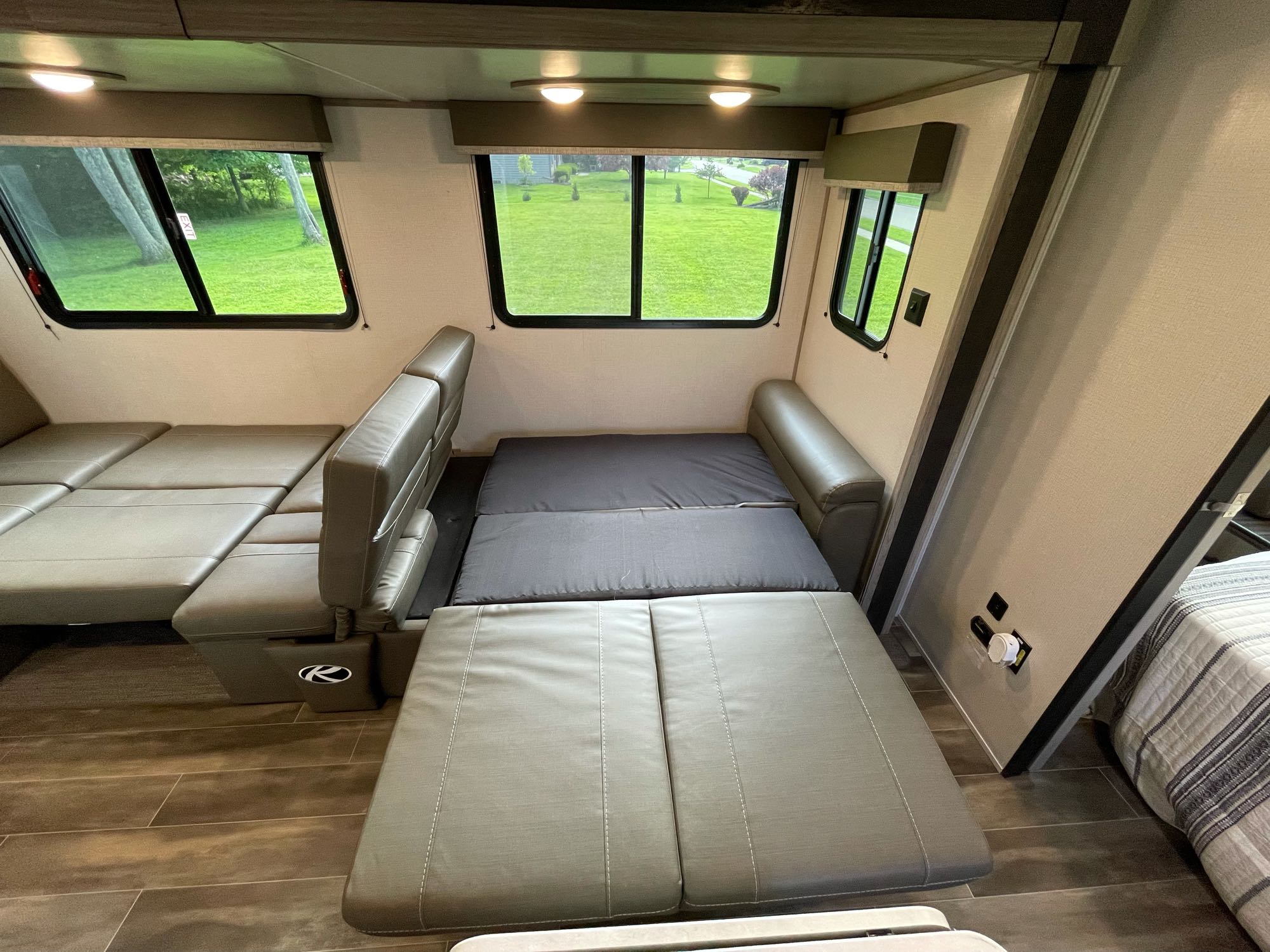 This RV rental offers a spacious interior with convertible seating and beds, plus scenic views from large windows.. Keystone RV Passport SL 2022