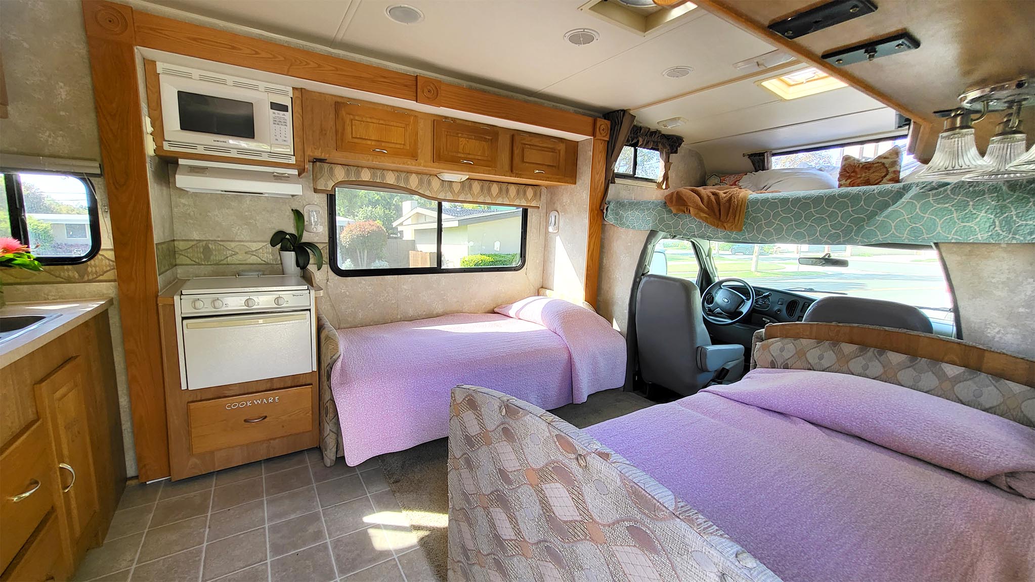 Explore this RV rental's inviting interior! Features a kitchen, bunk over cab, and two sofa beds for cozy stays.. Georgie Boy Maverick 2005