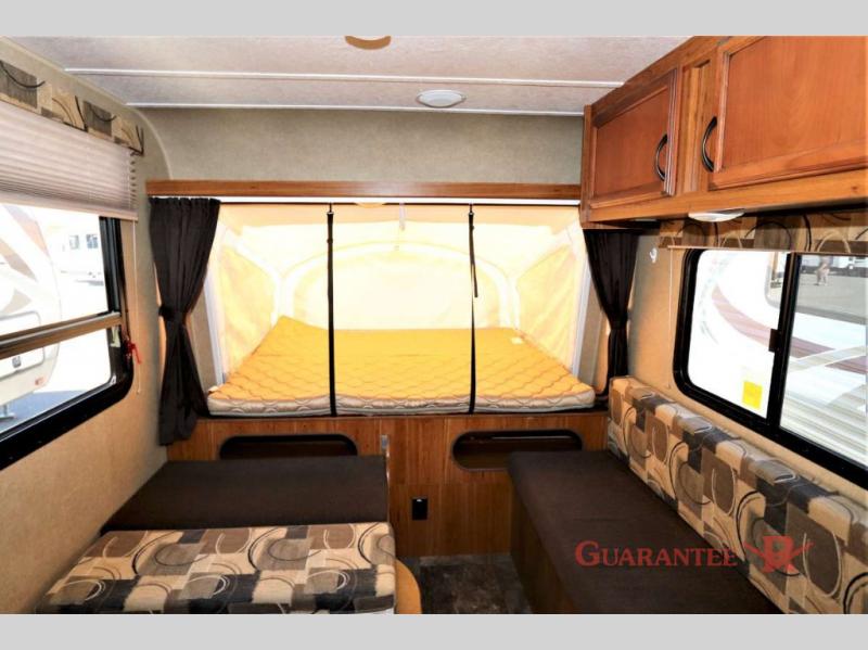Spacious RV rental interior with a cozy pop-out bed and comfortable seating, ideal for travel adventures.. Starcraft Launch 2016