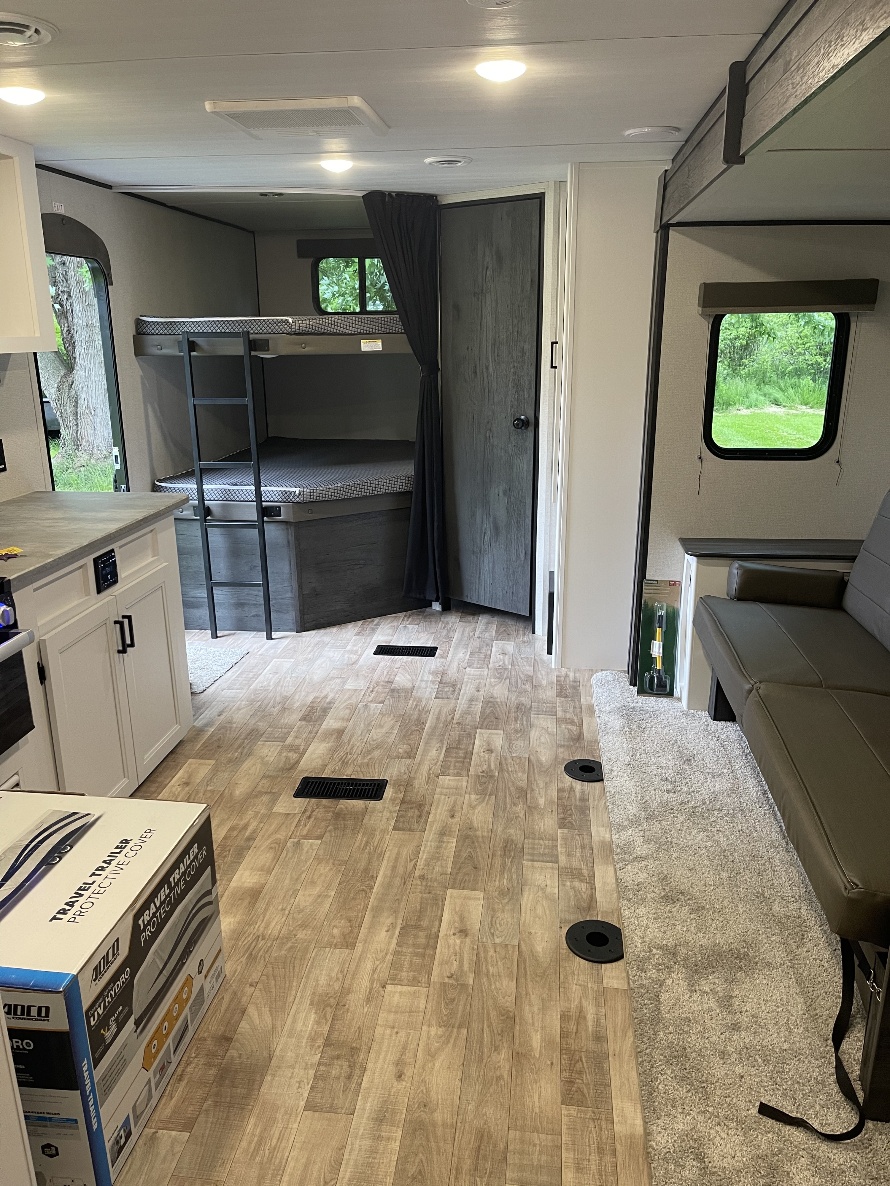 Spacious RV rental interior featuring modern bunk beds, a well-equipped kitchen area, and a comfortable living space.. Keystone Hideout 250BH 2022