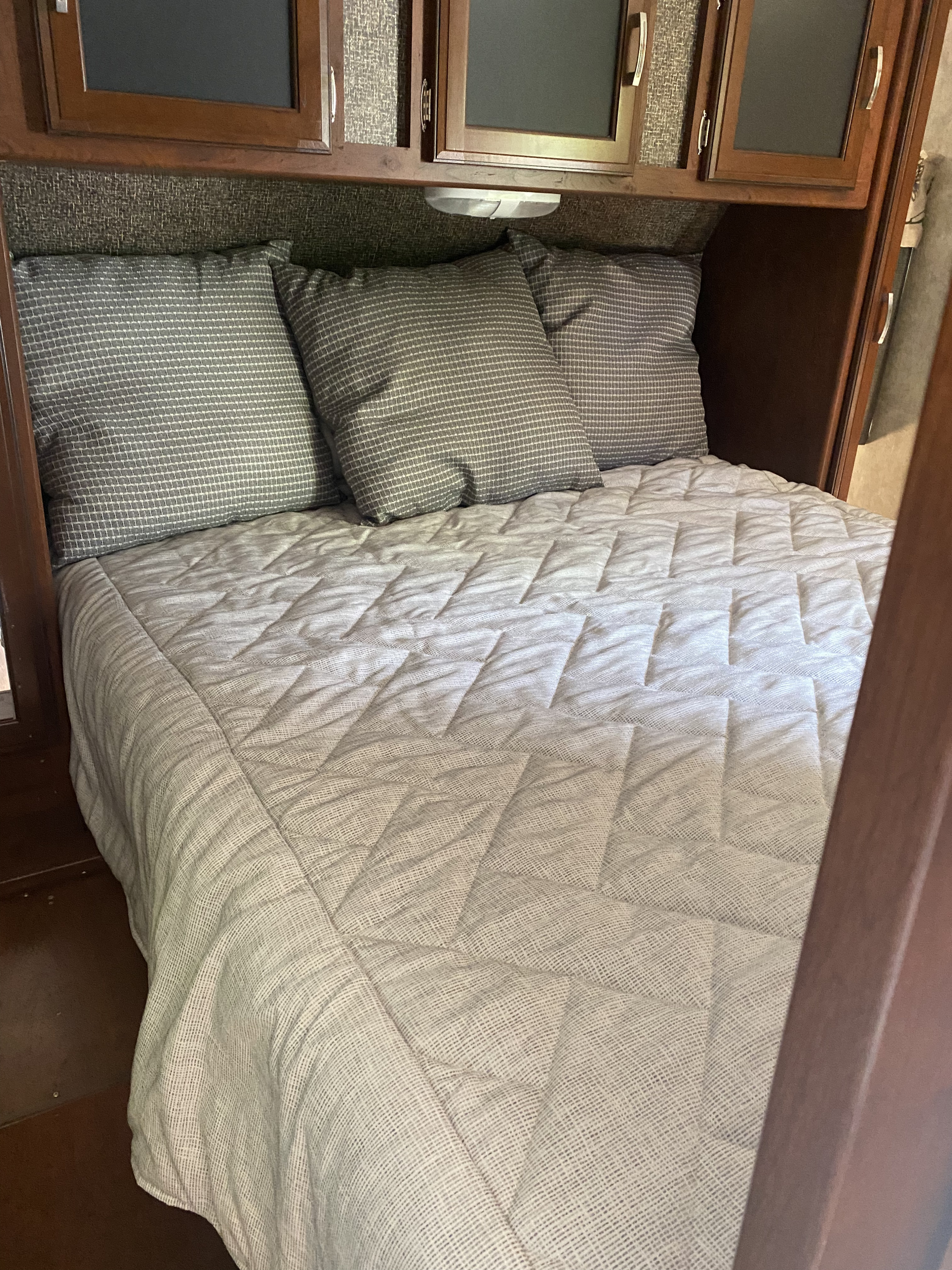 Queen bed with to sliding doors for privacy. . Keystone RV Passport Grand Touring 2017