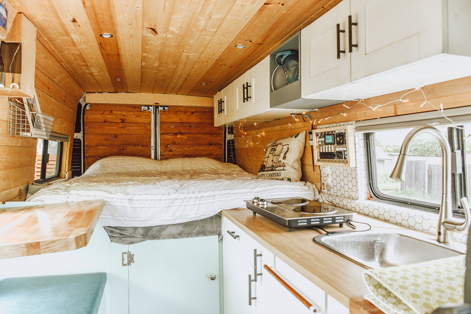 Explore this modern RV rental's inviting interior: wood accents, comfy bed, and kitchenette with sink/cooktop.. Other Other 2016