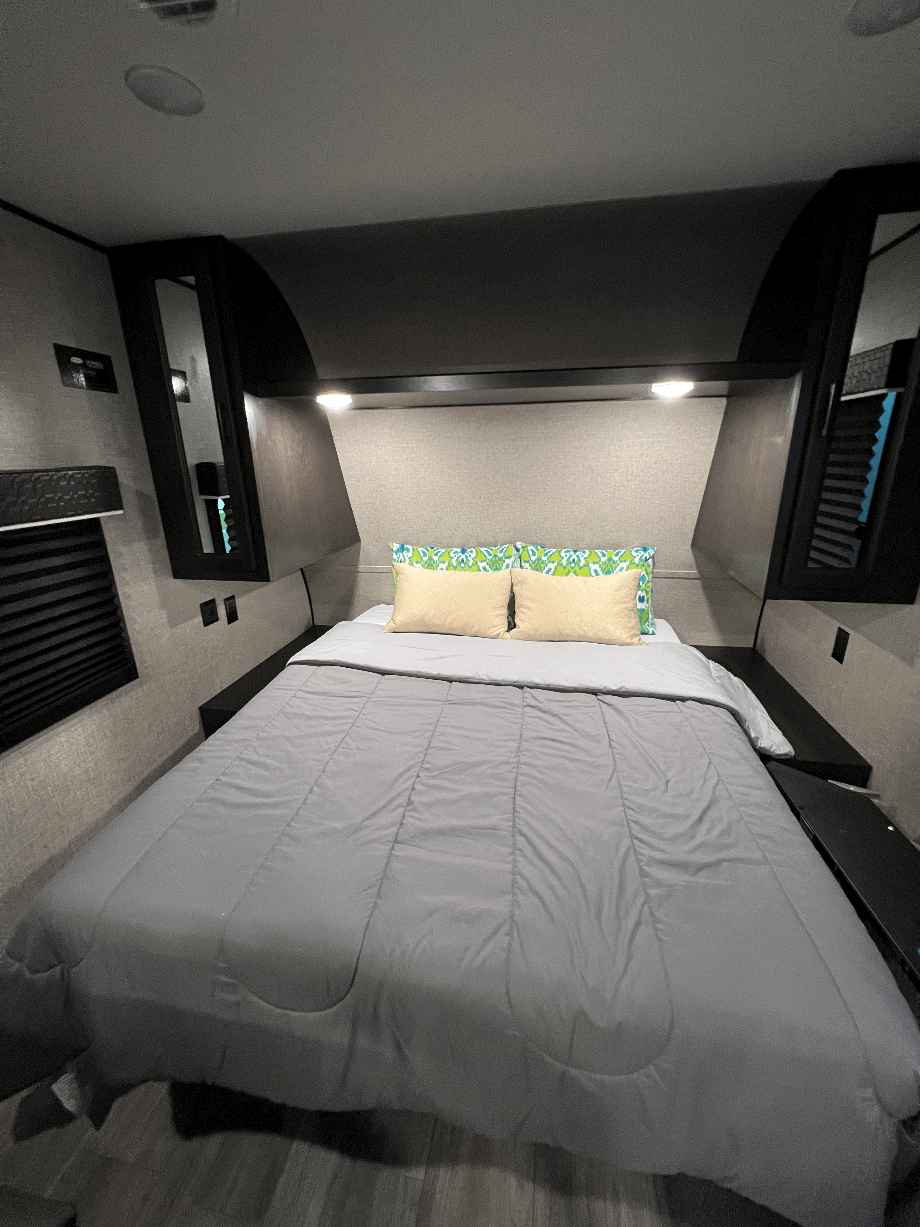 Cozy RV rental bedroom with a comfortable bed, overhead lighting, and compact storage, perfect for travel.. Jayco Jay Flight SLX 8 2022