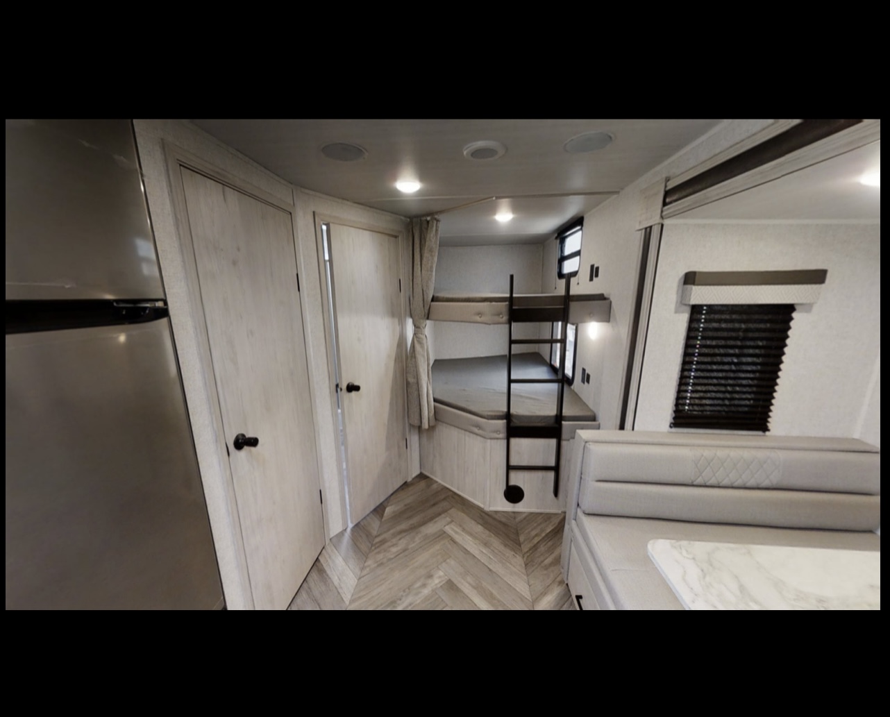 Spacious rv rental interior showing bunk beds, dinette, kitchen, and storage. Ideal for trips.. East to West Della Terra 2022