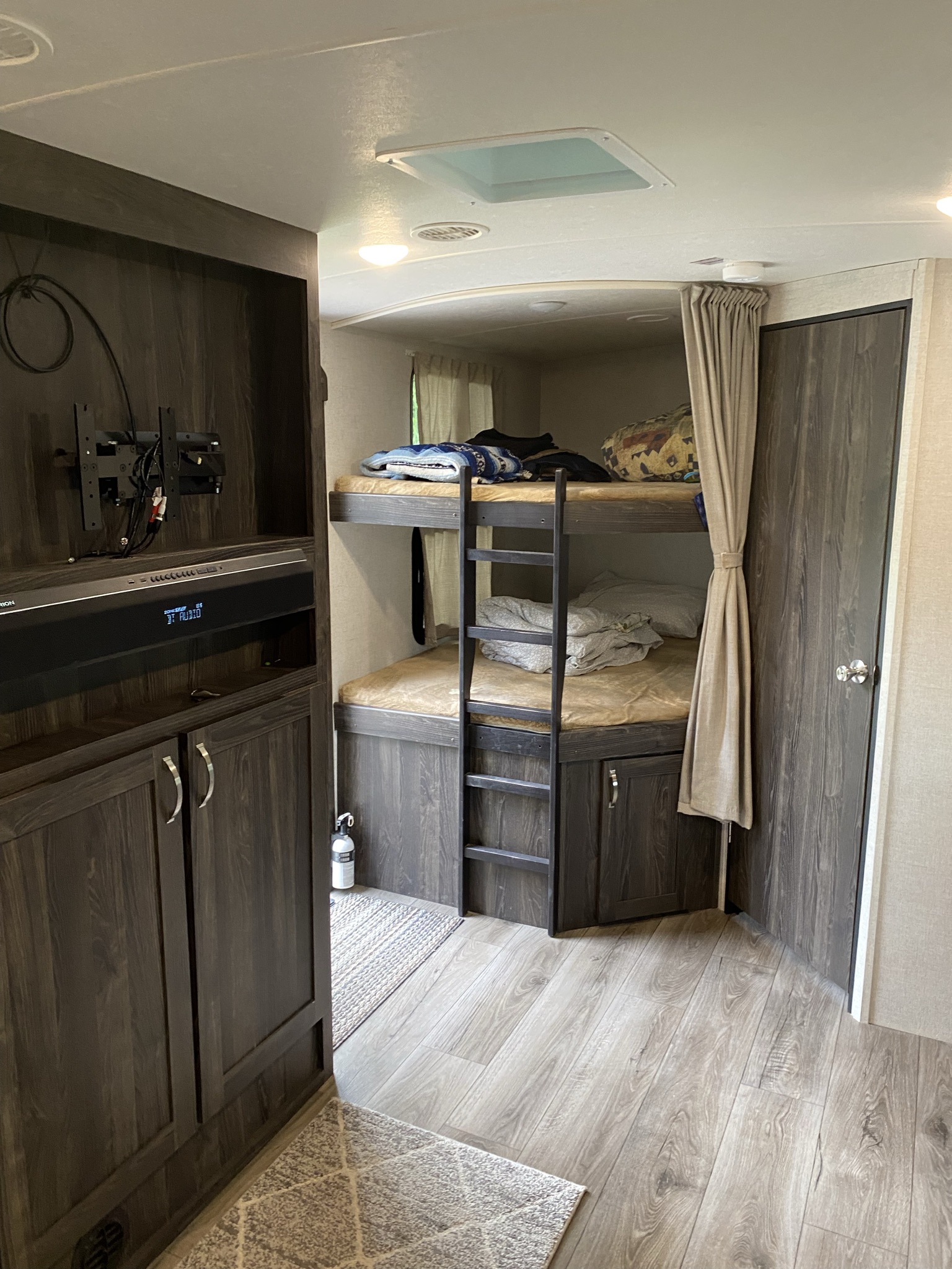 This RV rental bunkhouse area offers cozy beds & entertainment for travelers.. Highland Ridge RV Open Range Ultra Lite 2020