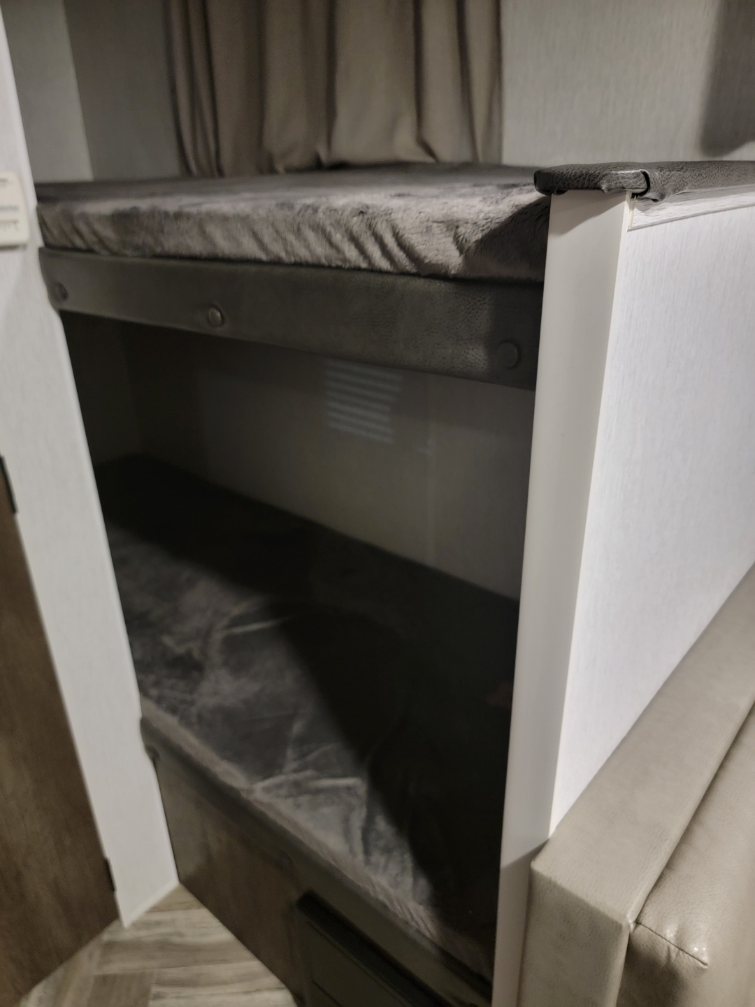 Cozy gray bunk beds inside an RV rental. A compact sleeping area, perfect for travel accommodation.. Forest River Salem 2022