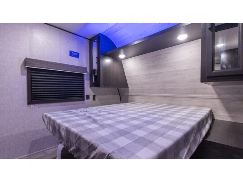 Explore comfort in this RV rental bedroom. Features a comfortable bed, window, and ambient lighting.. Jayco Jay Series 2022