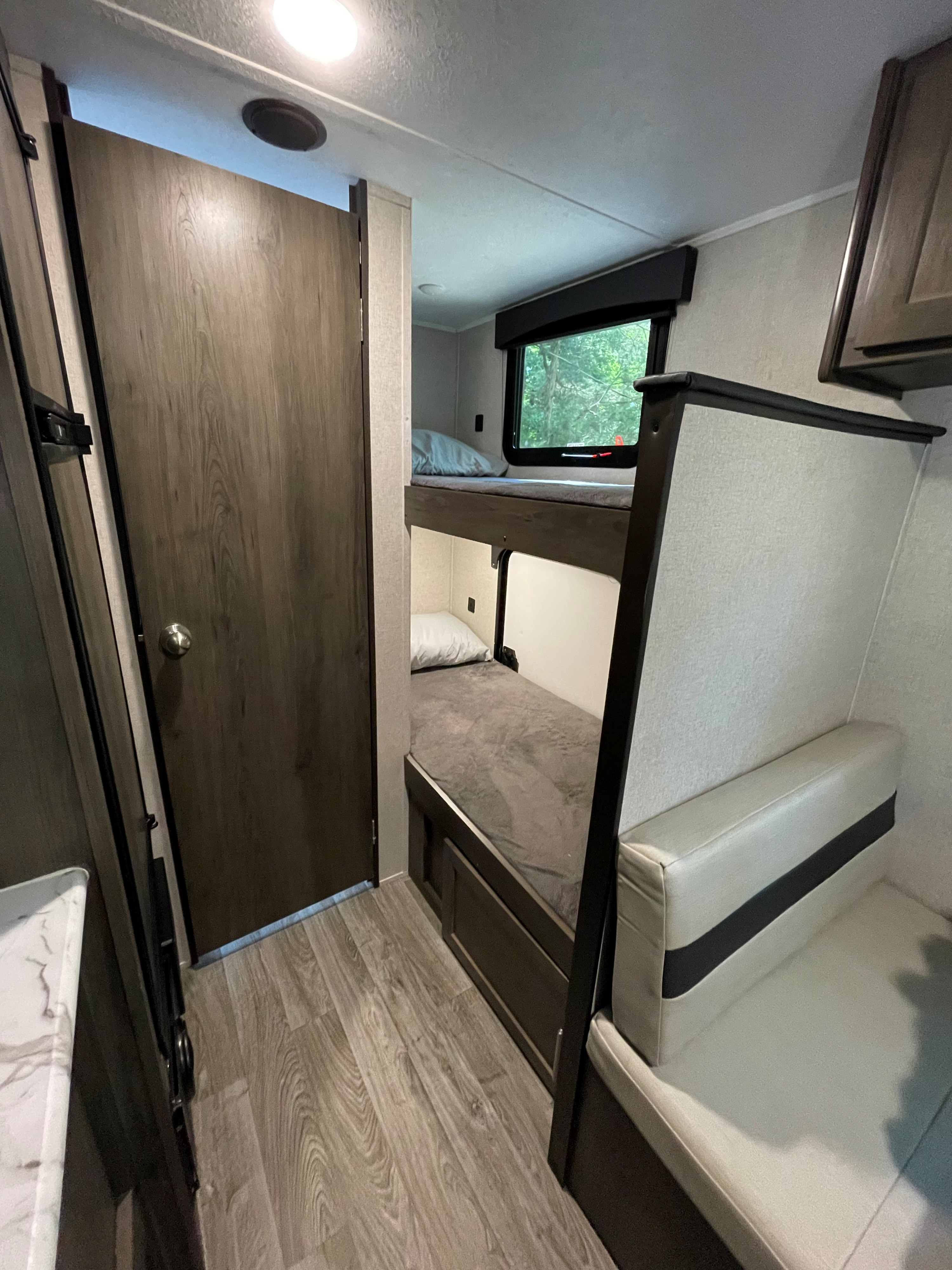 RV rental interior: bunk beds, a dinette, and a door. Perfect for family adventures and camping comfort.. Clipper Clipper Trailer 2020
