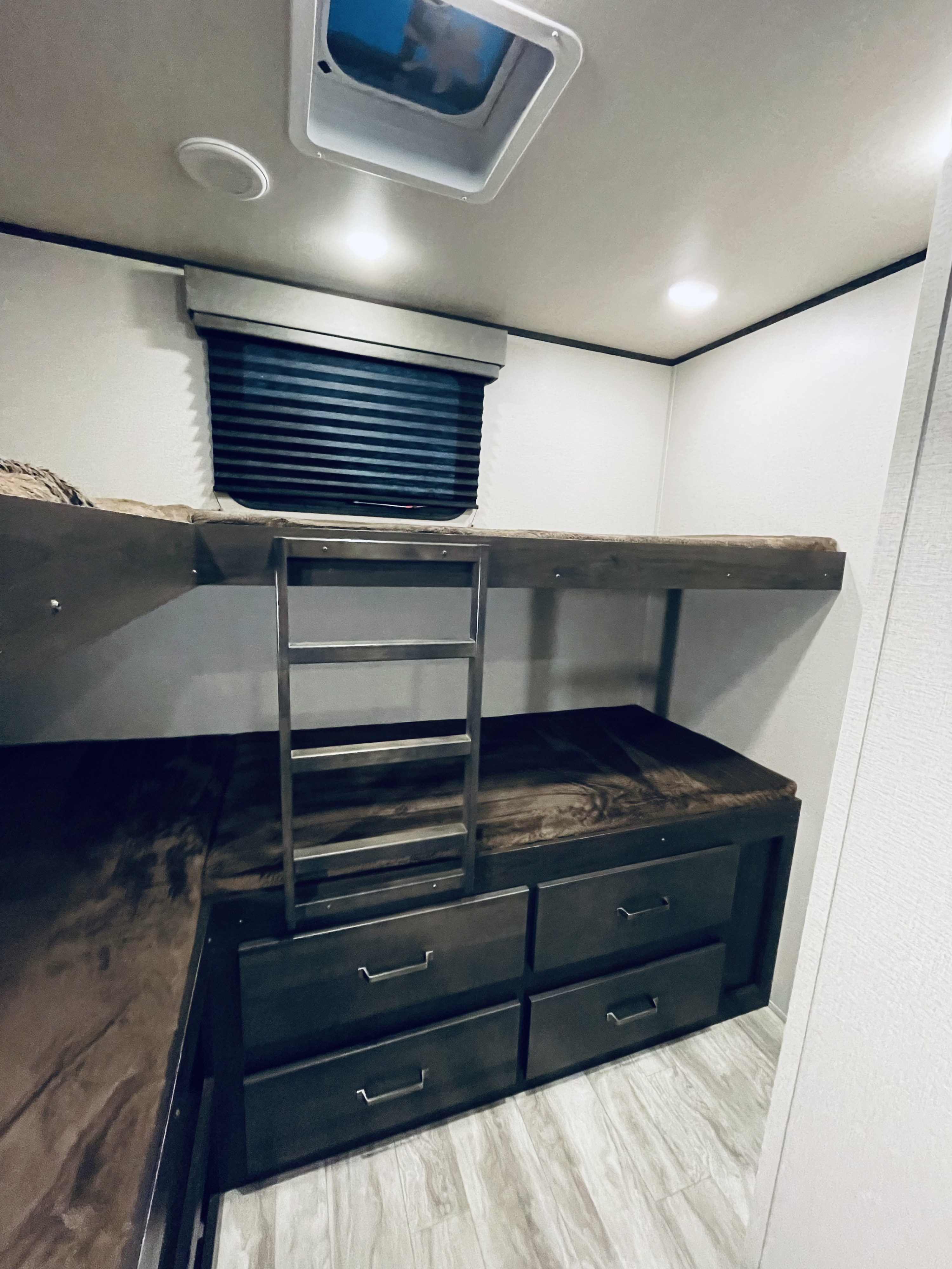 RV rental with stacked bunk beds, a ladder, and ample under-bed storage for an organized interior.. Grand Design Transcend 2020