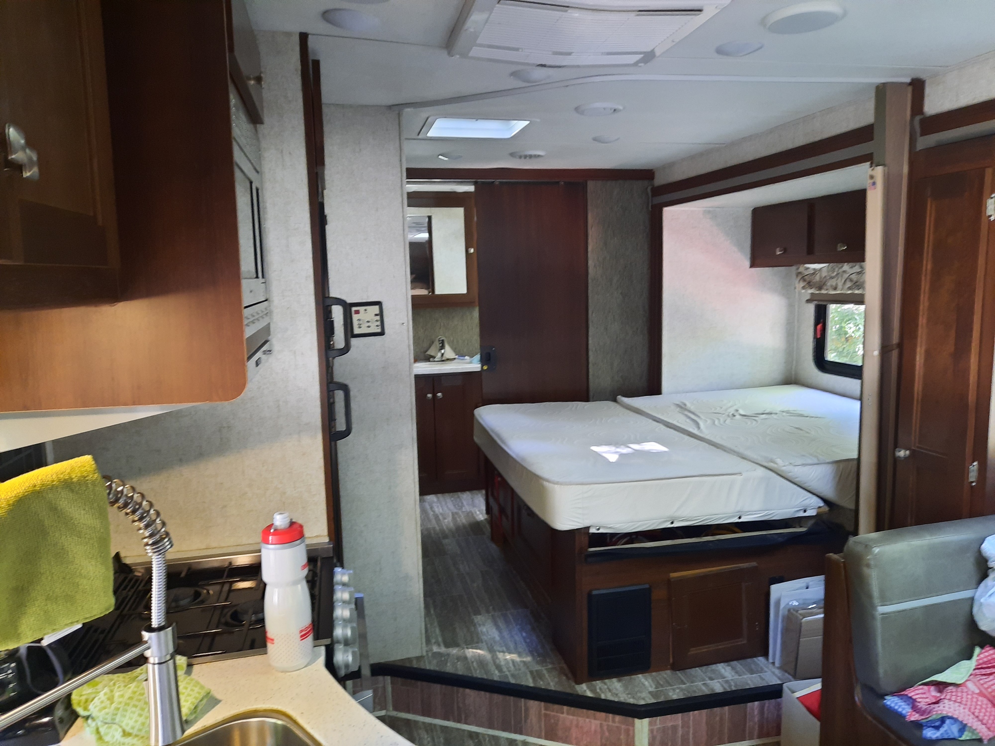 RV rental interior showcasing a kitchen area with sink/stove, a hallway, and an elevated bedroom for travel.. Forest River Other 2018
